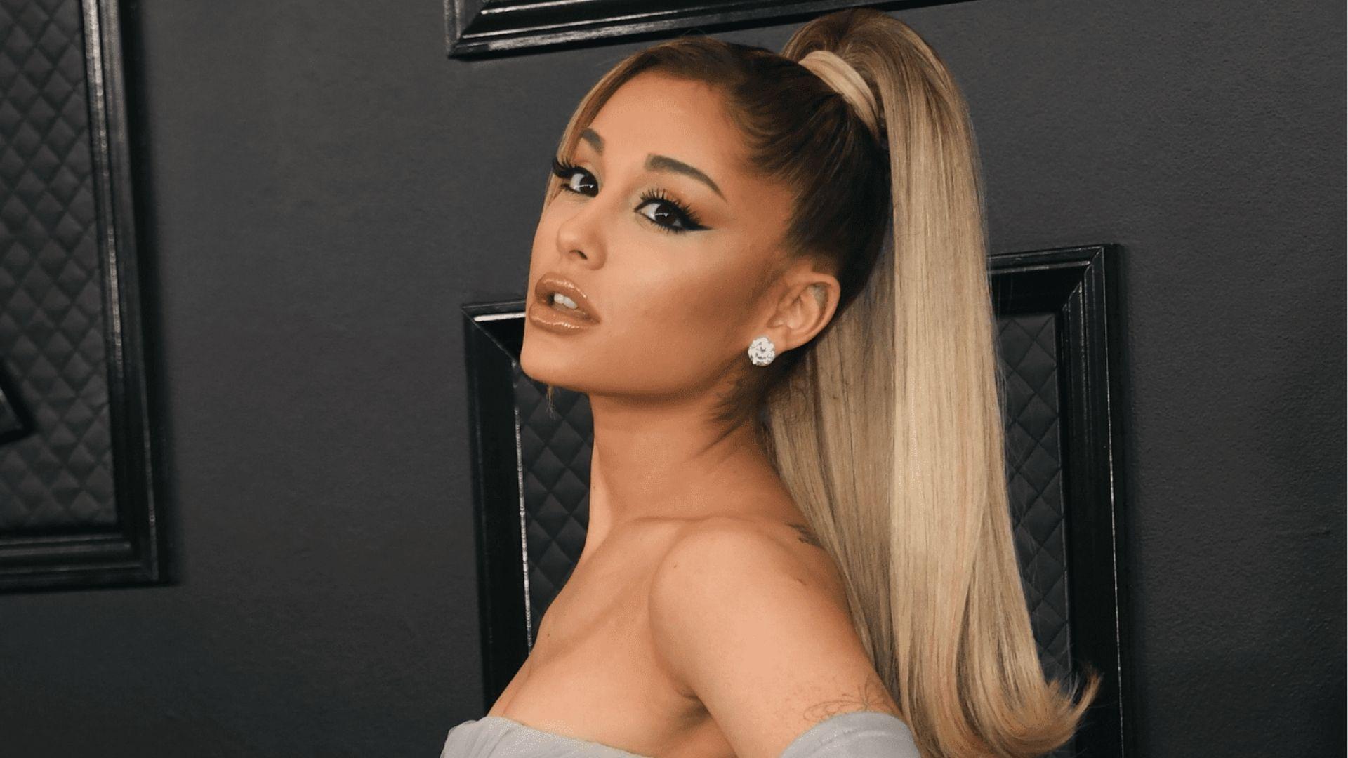 Ariana Grande at Grammys with signature high ponytail and strapless gray gown.