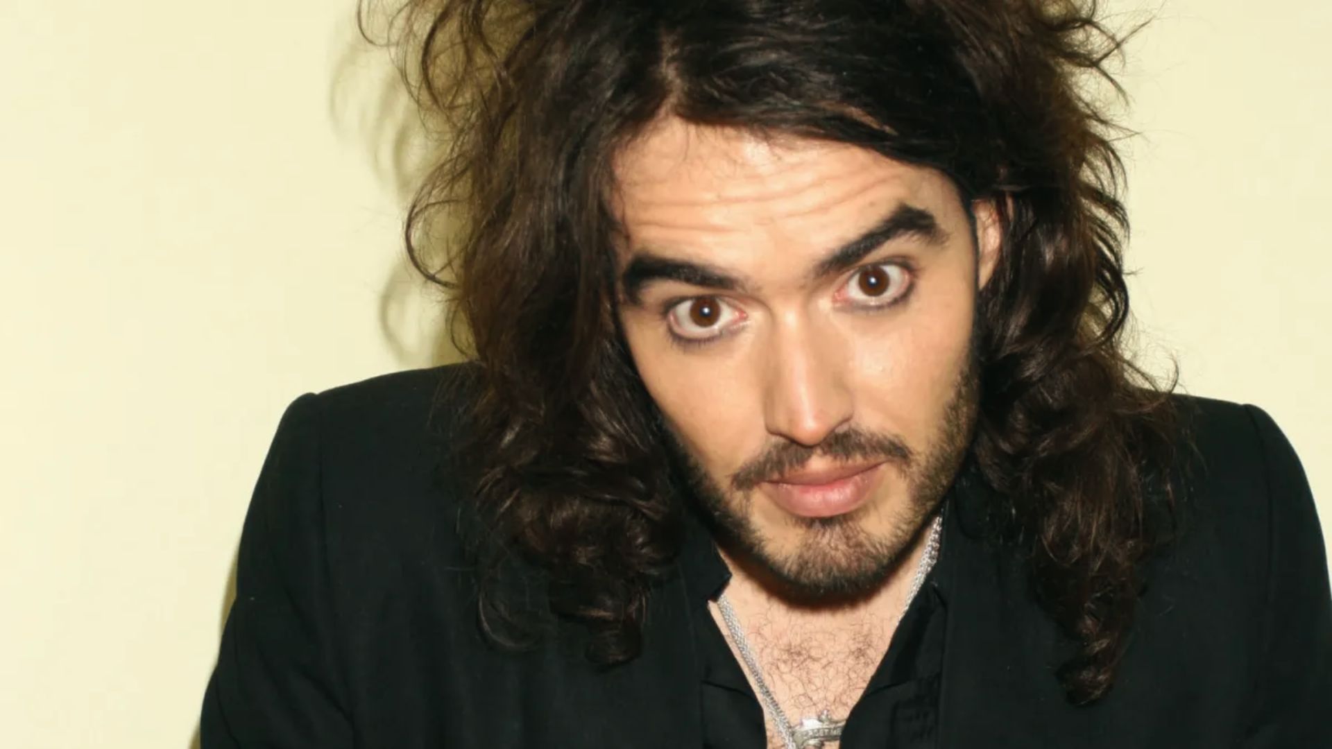 Russell Brand, with short hair, showcases his new Look.