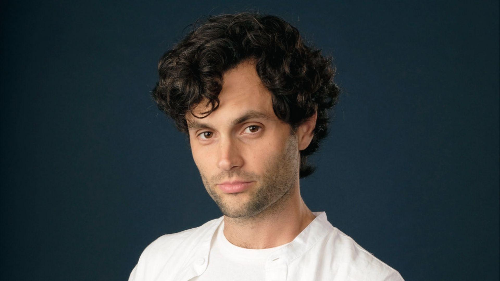 Penn Badgley displays a casual Medium-Length Curly Side Part with the middle part.