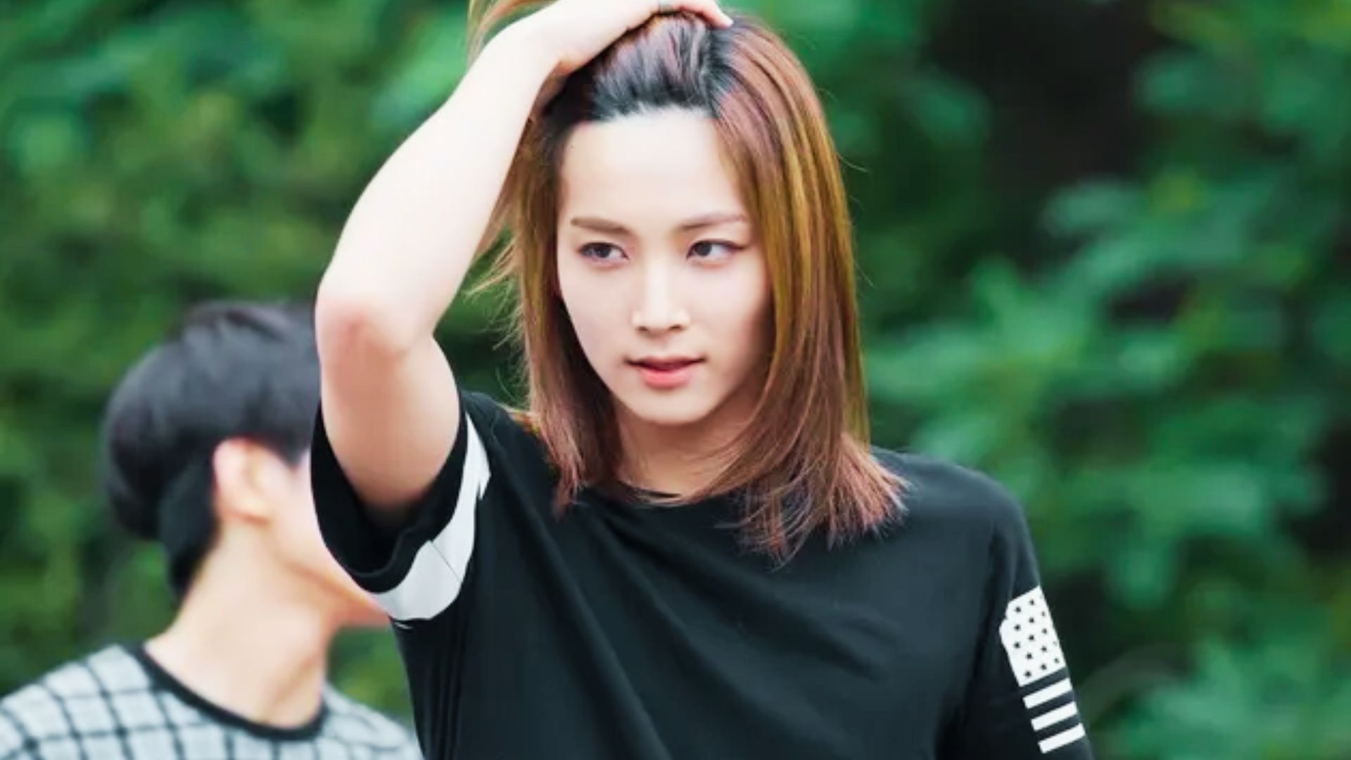 Close-up of Jeonghan with wavy platinum blonde hair falling past his chin.