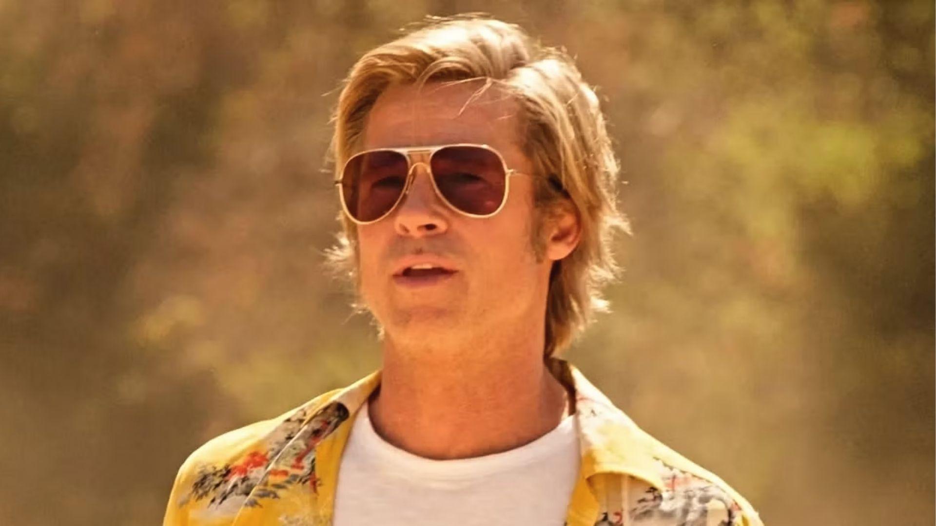 Brad Pitt in Once Upon a Time in Hollywood, windblown medium hair, sunglasses, sunny set