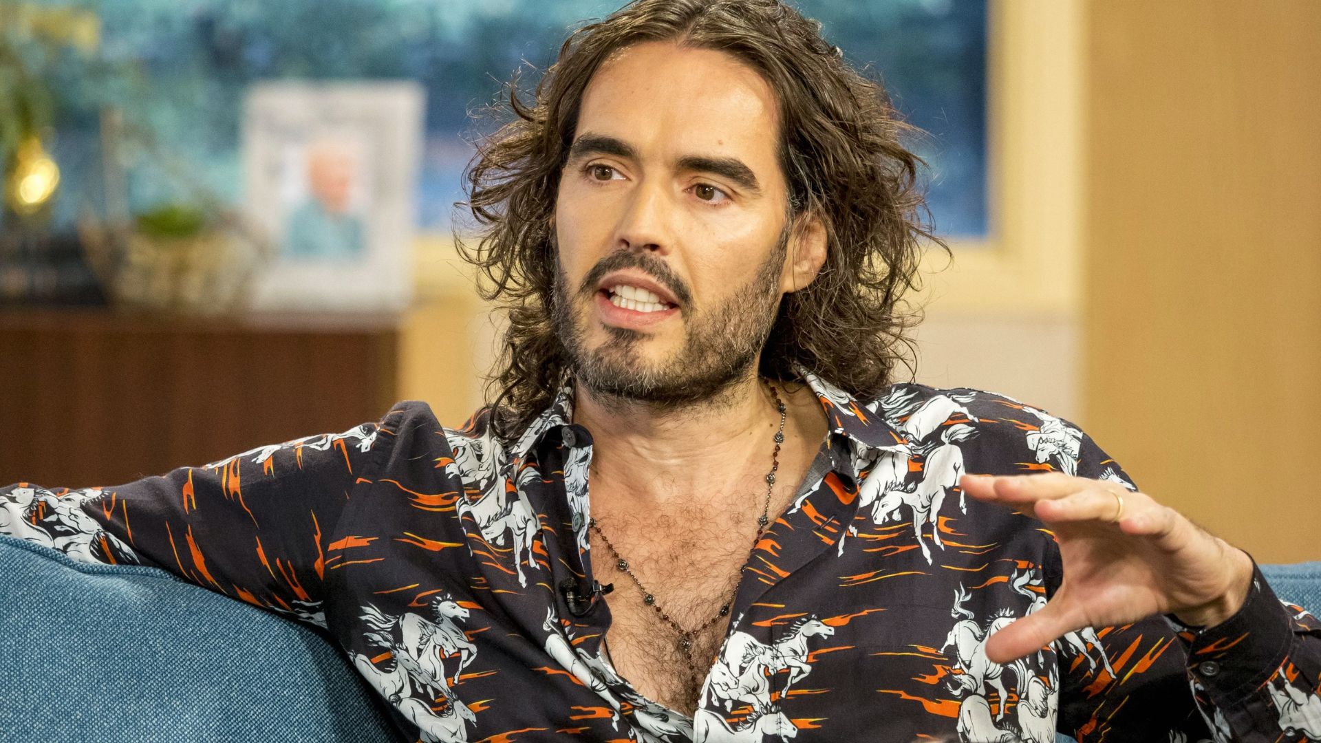Russell Brand on the Show, featuring his unique hairstyle while discussing various topics with the presenters.