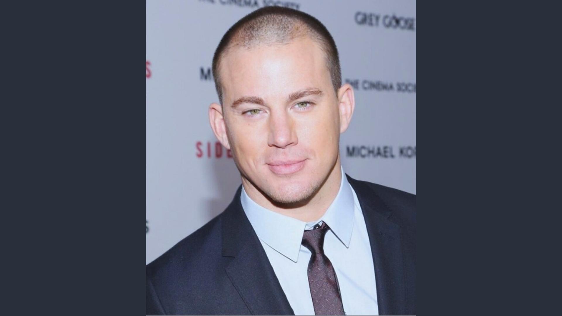 Channing Tatum on the red carpet with a tight military buzz cut, wearing a suit and tie for polished style.