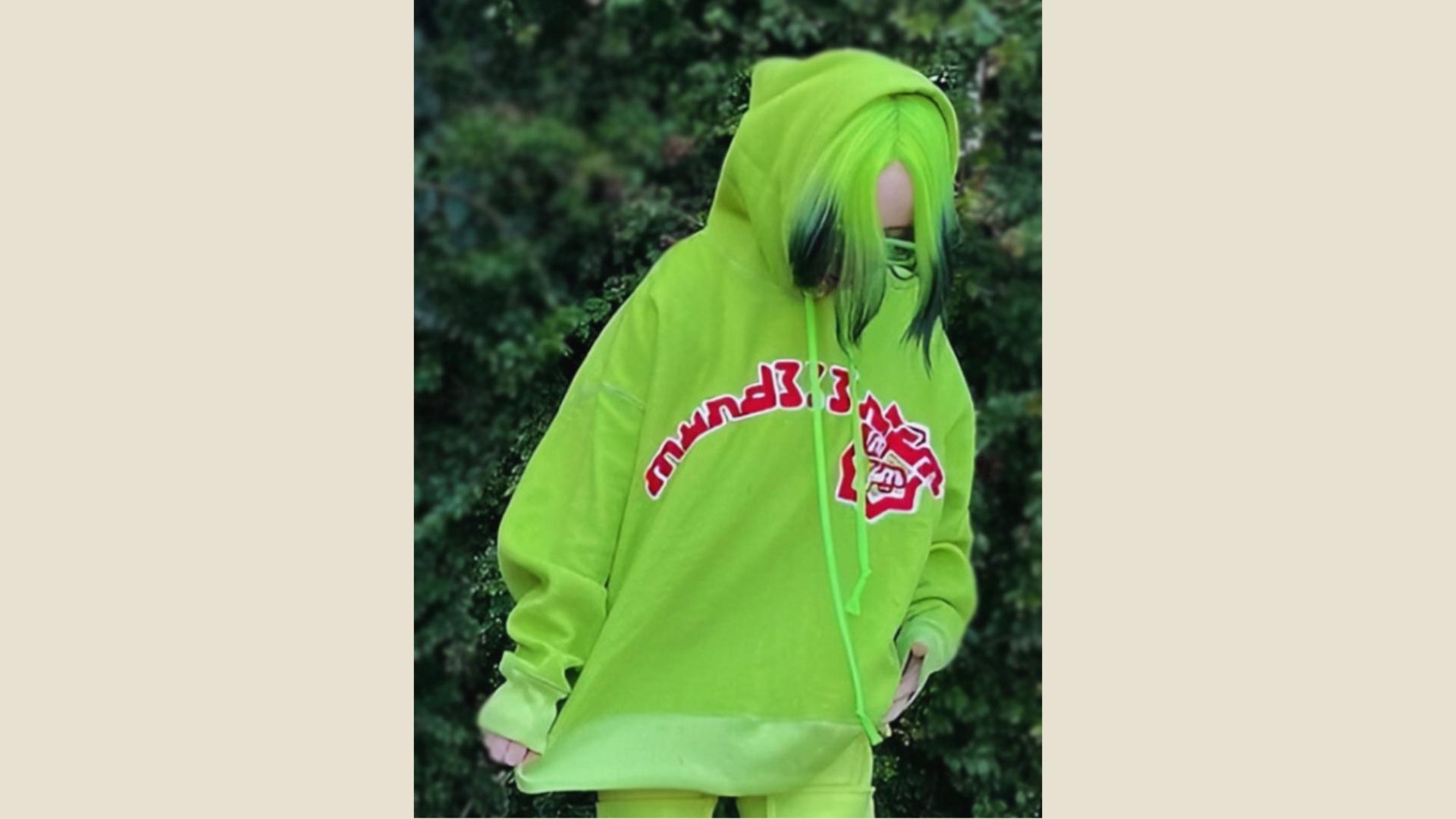 Billie Eilish wears a neon green oversized hoodie and matching pants with green-black hair for monochrome streetwear look.