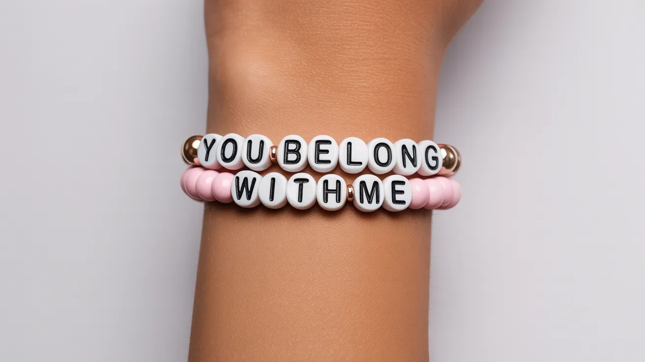close-up wrist shot featuring a pink and white bracelet with cube beads spelling YOU BELONG WITH ME in bold readable letters.