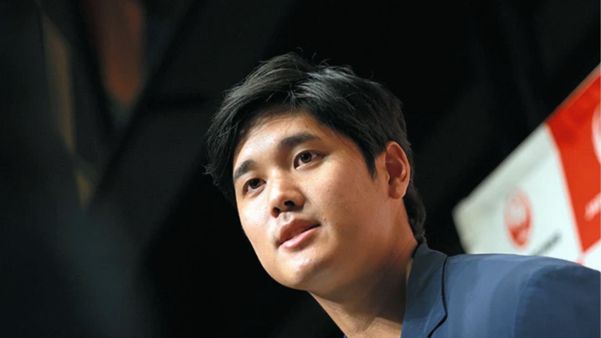 Shohei Ohtani at press event showing neat side-parted haircut with longer top