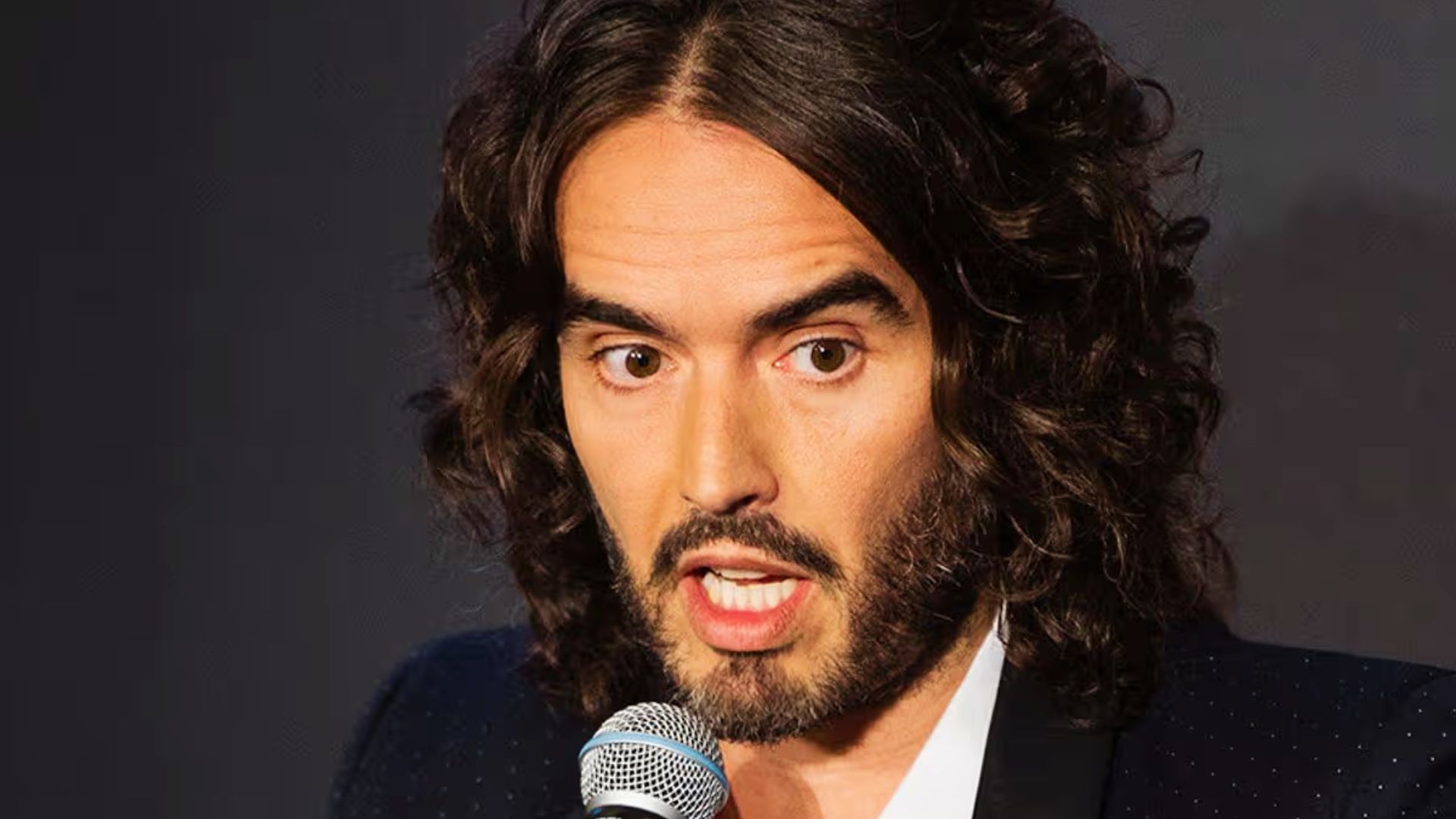 A close-up of Russell Brand's hair, highlighting tapered sides and a textured top for hairstyle inspiration.