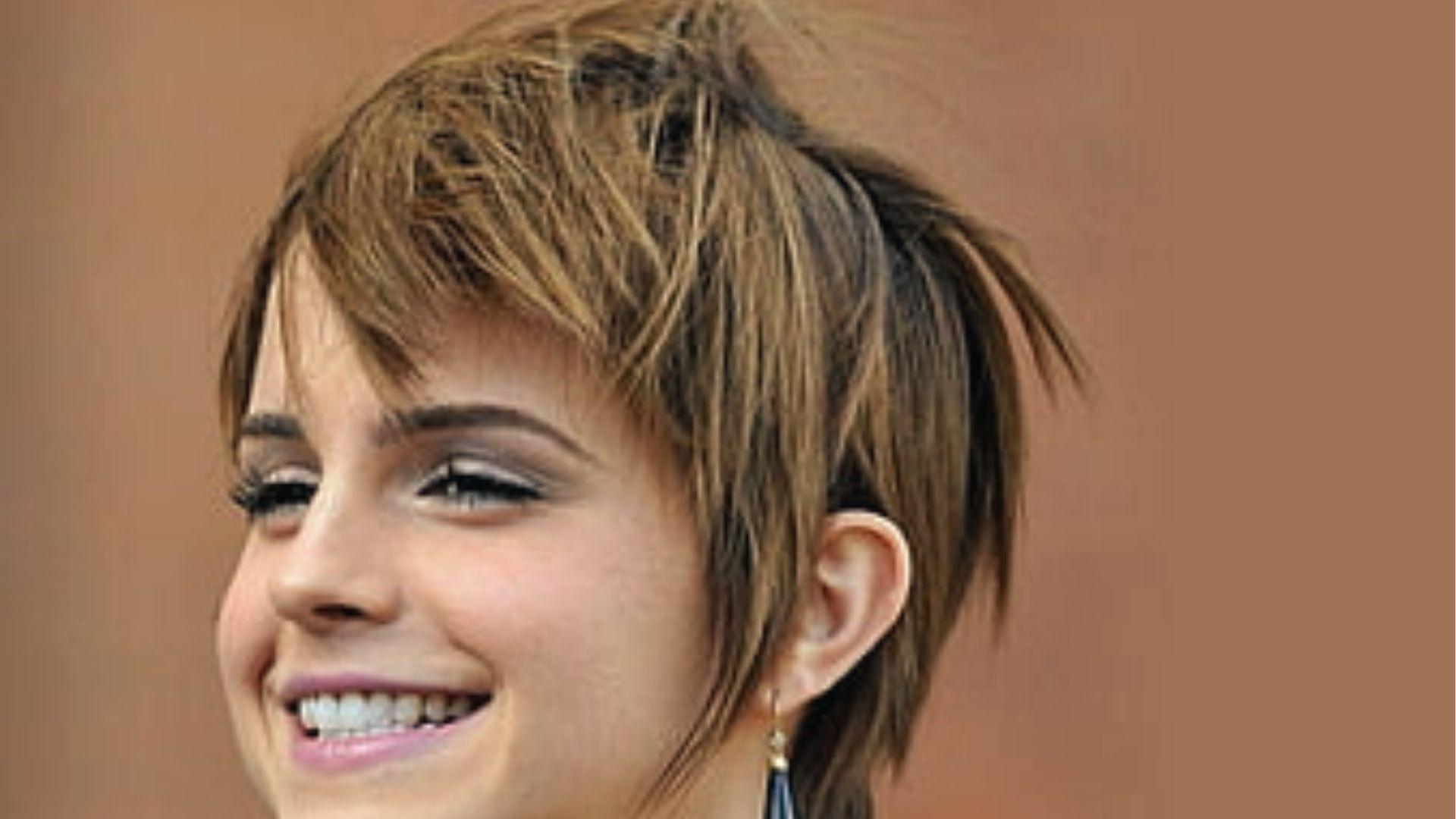 Emma Watson smiles showing Asymmetrical Pixie Cut