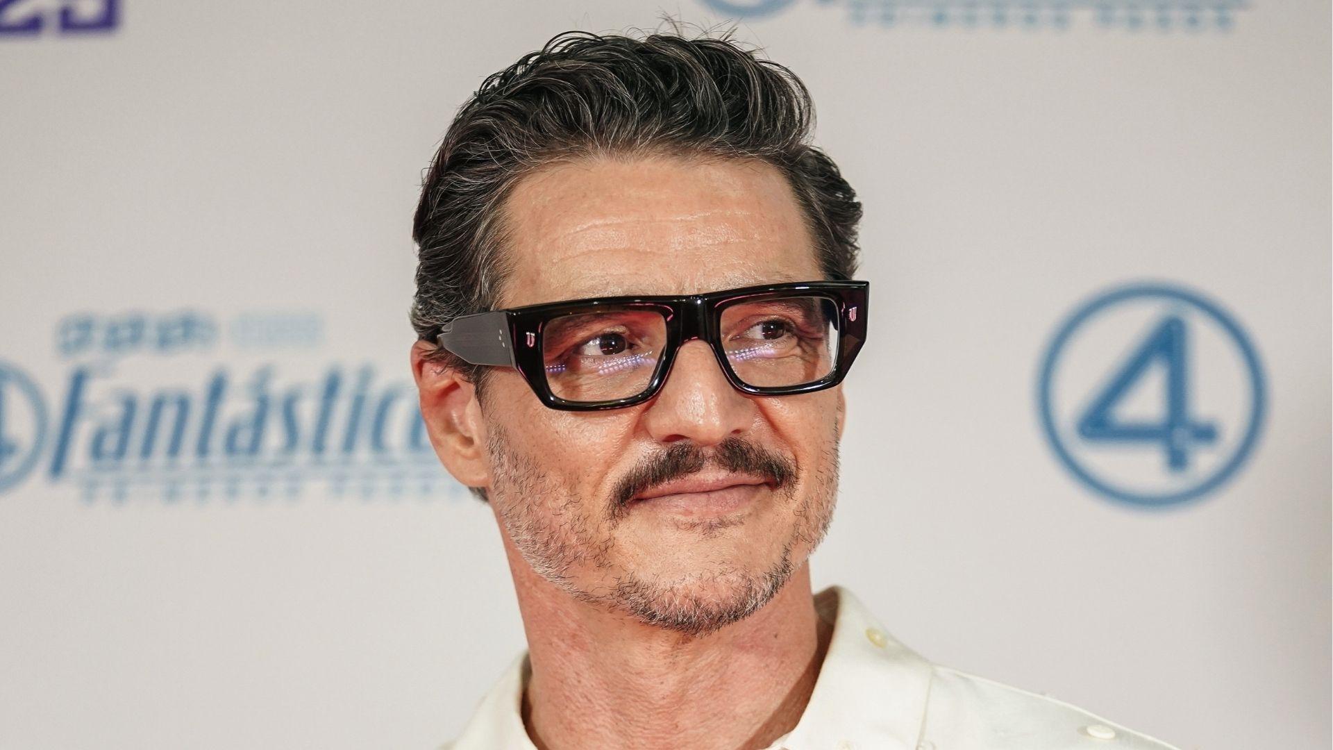 Pedro Pascal with swept-back salt and pepper haircut wearing black glasses at Fantastic Four event