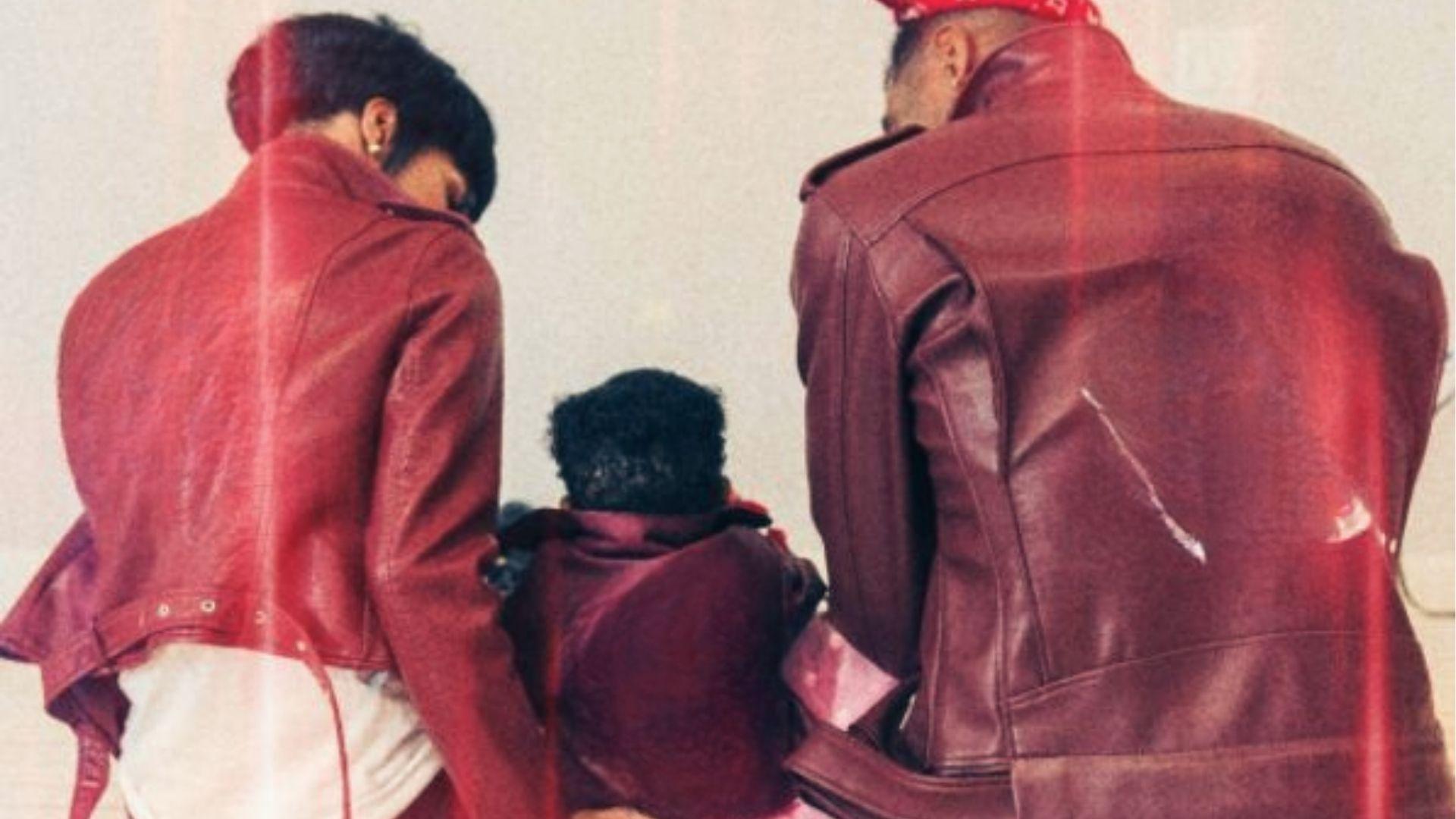 Teyana Taylor and family in matching burgundy leather wedding jackets from behind