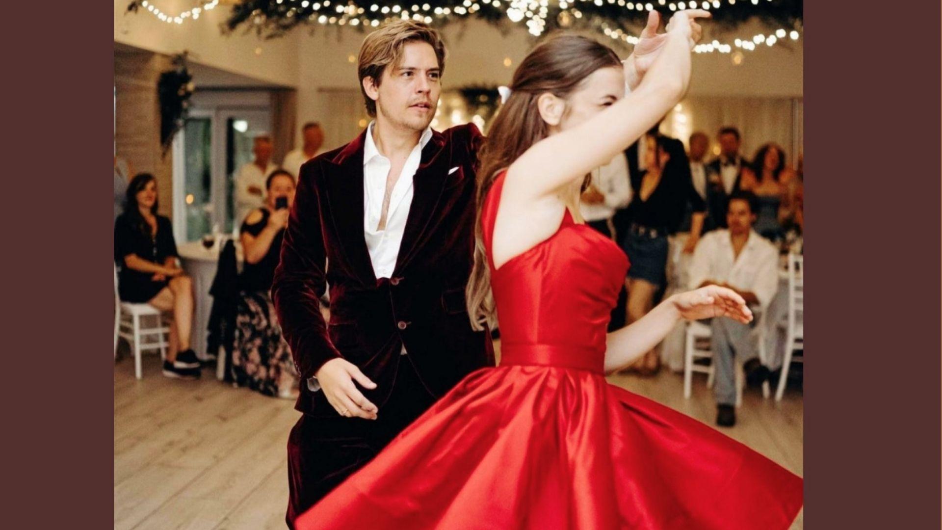 Barbara Palvin wearing a red Midi dress as part of her bridal look.