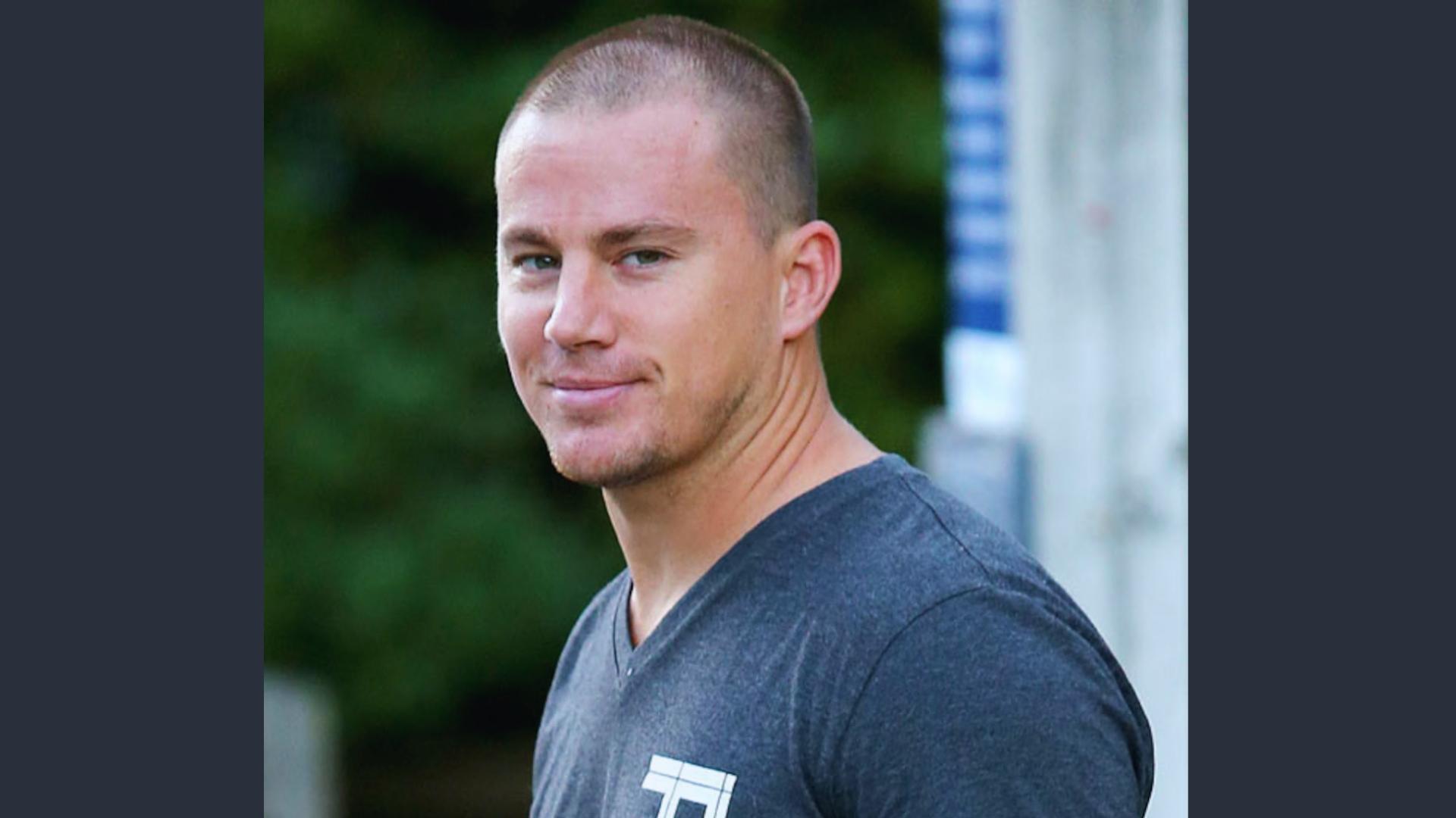Channing Tatum wears a textured Ivy League buzz cut with slight length on top, styled casually at a press event.