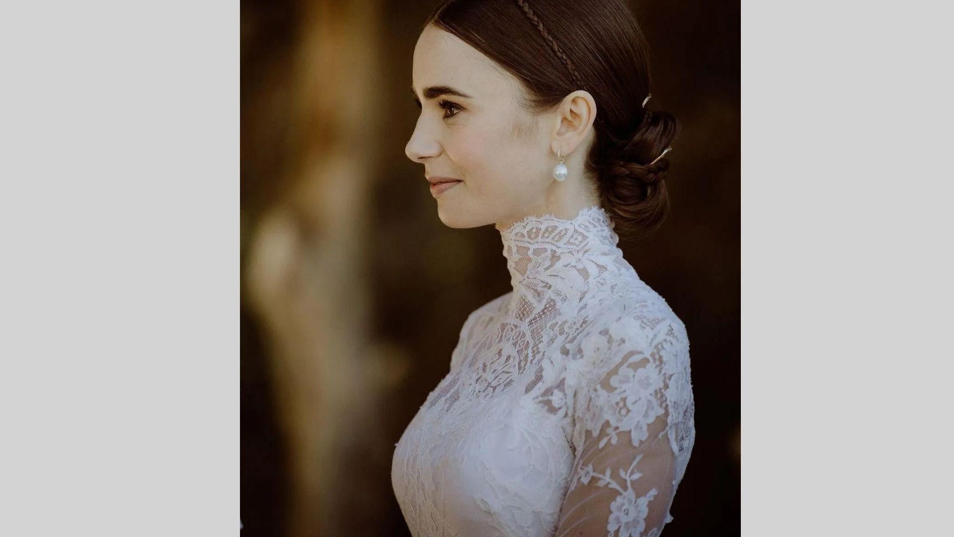 Profile of bride in high neck lace gown with braided bun and pearl earrings outdoors
