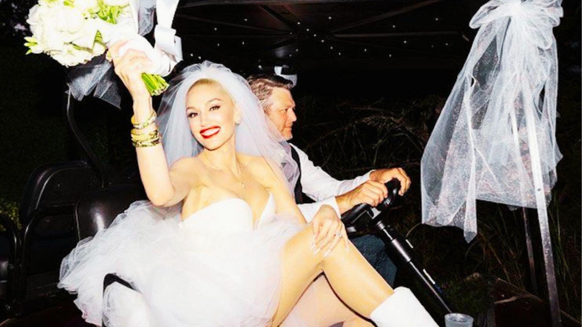 Blonde bride in tulle mini dress and veil rides golf cart holding bouquet at night