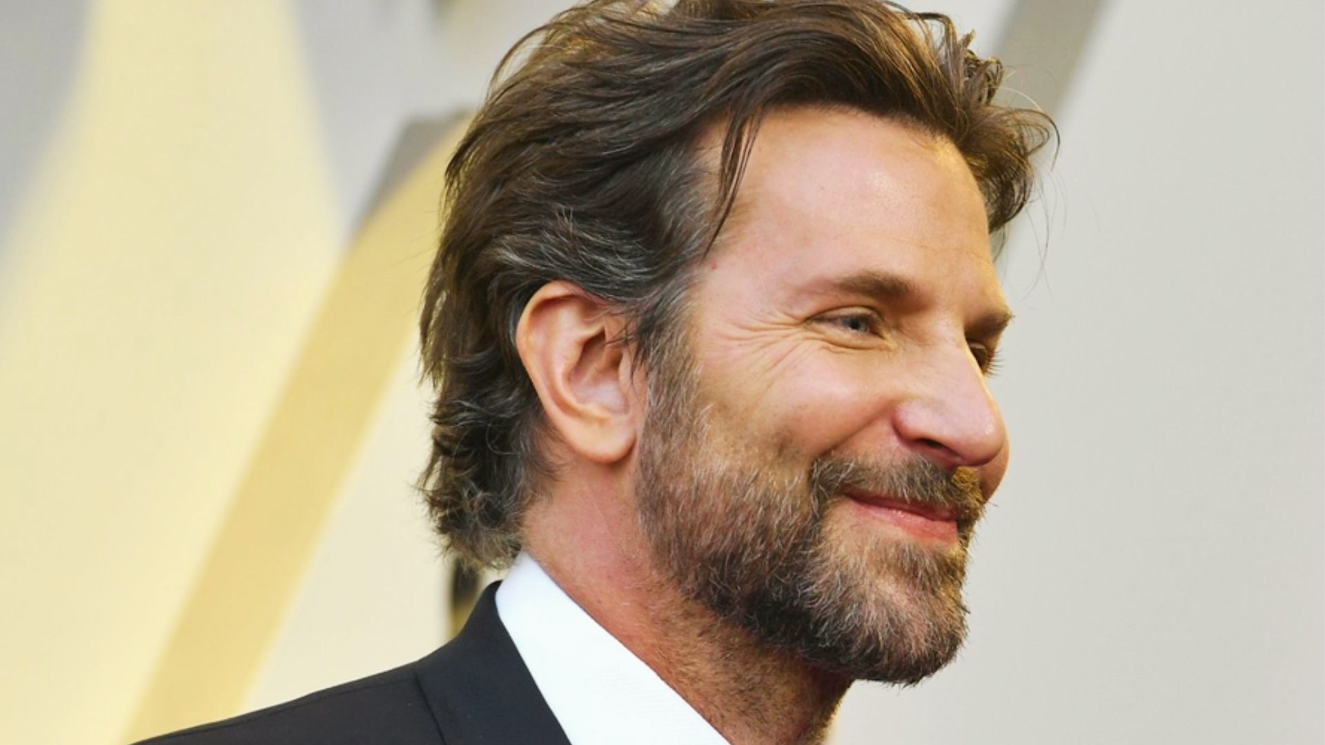 Bradley Cooper showcasing a stylish haircut with Wavy Bradley Cooper Haircut.