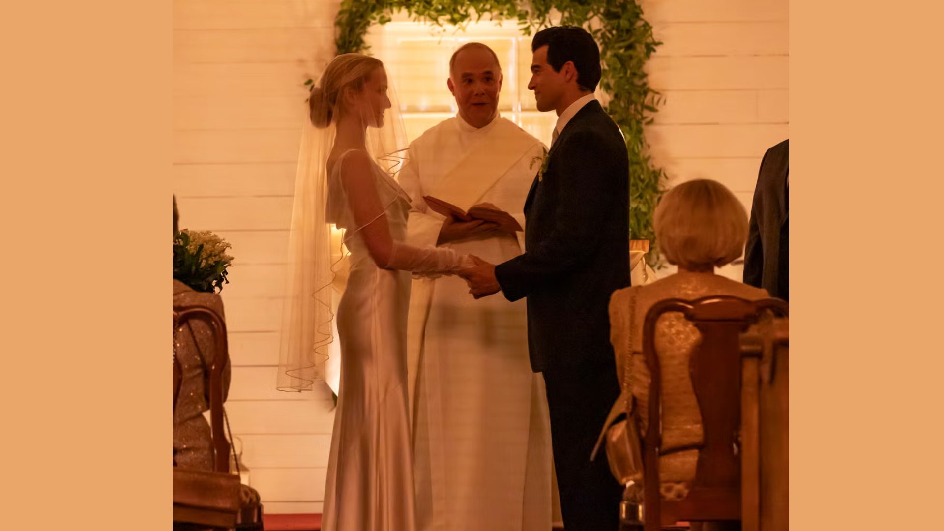 "A couple stands before a priest in a wedding ceremony. The bride wears a satin gown and veil, the groom a dark suit. Warm, intimate atmosphere."