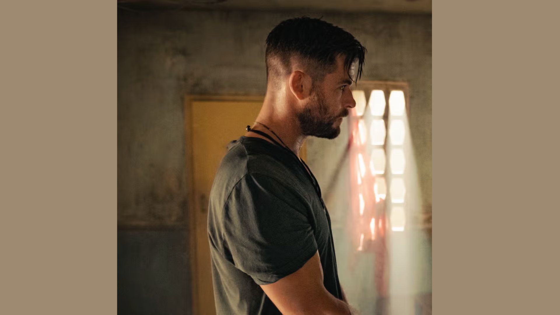 A bearded man showcasing a messy crop haircut with fringe, inspired by Chris Hemsworth's style.