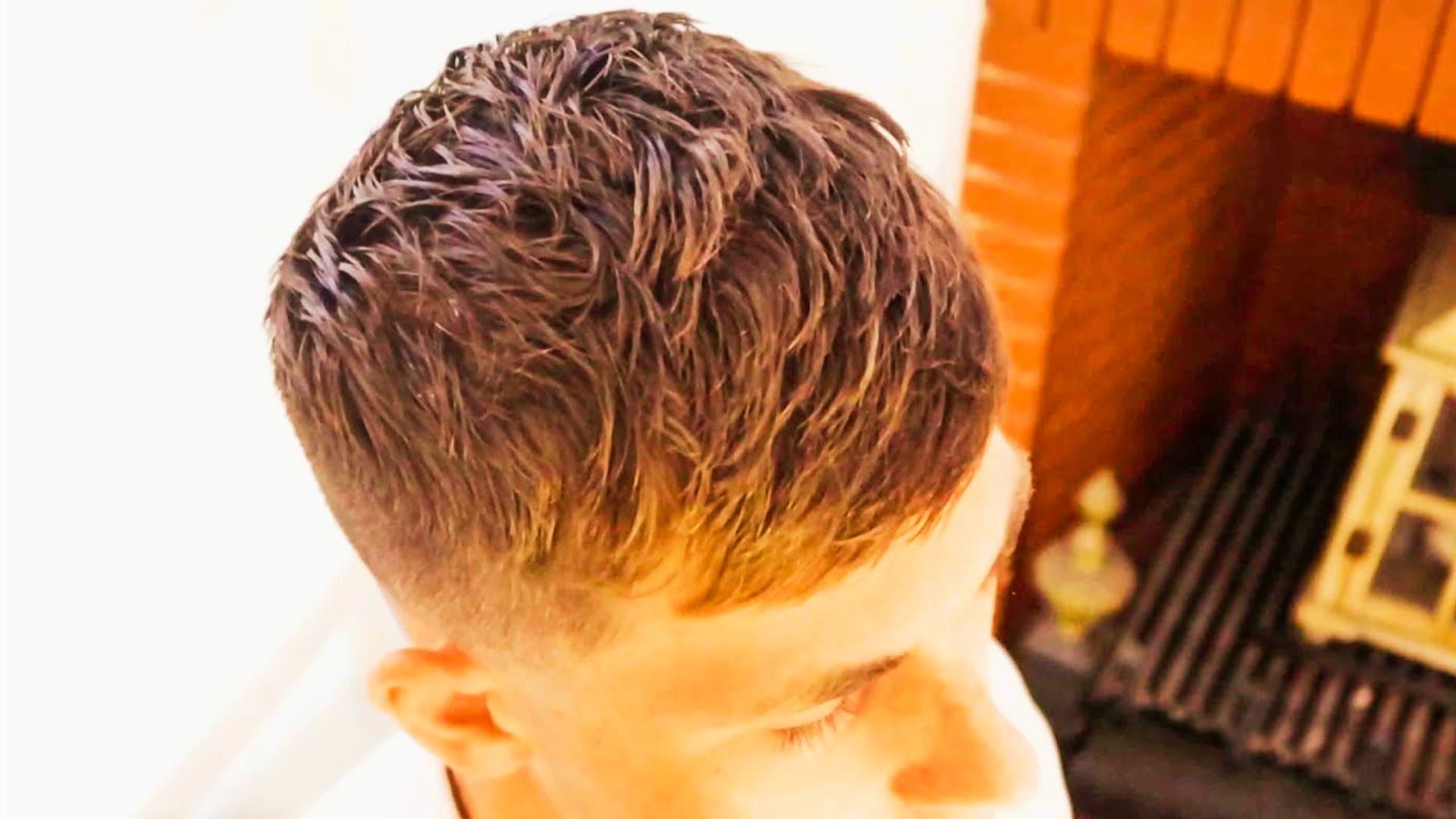 Top-down view of a short textured crop with faded sides, styled with a wet, messy finish on top.