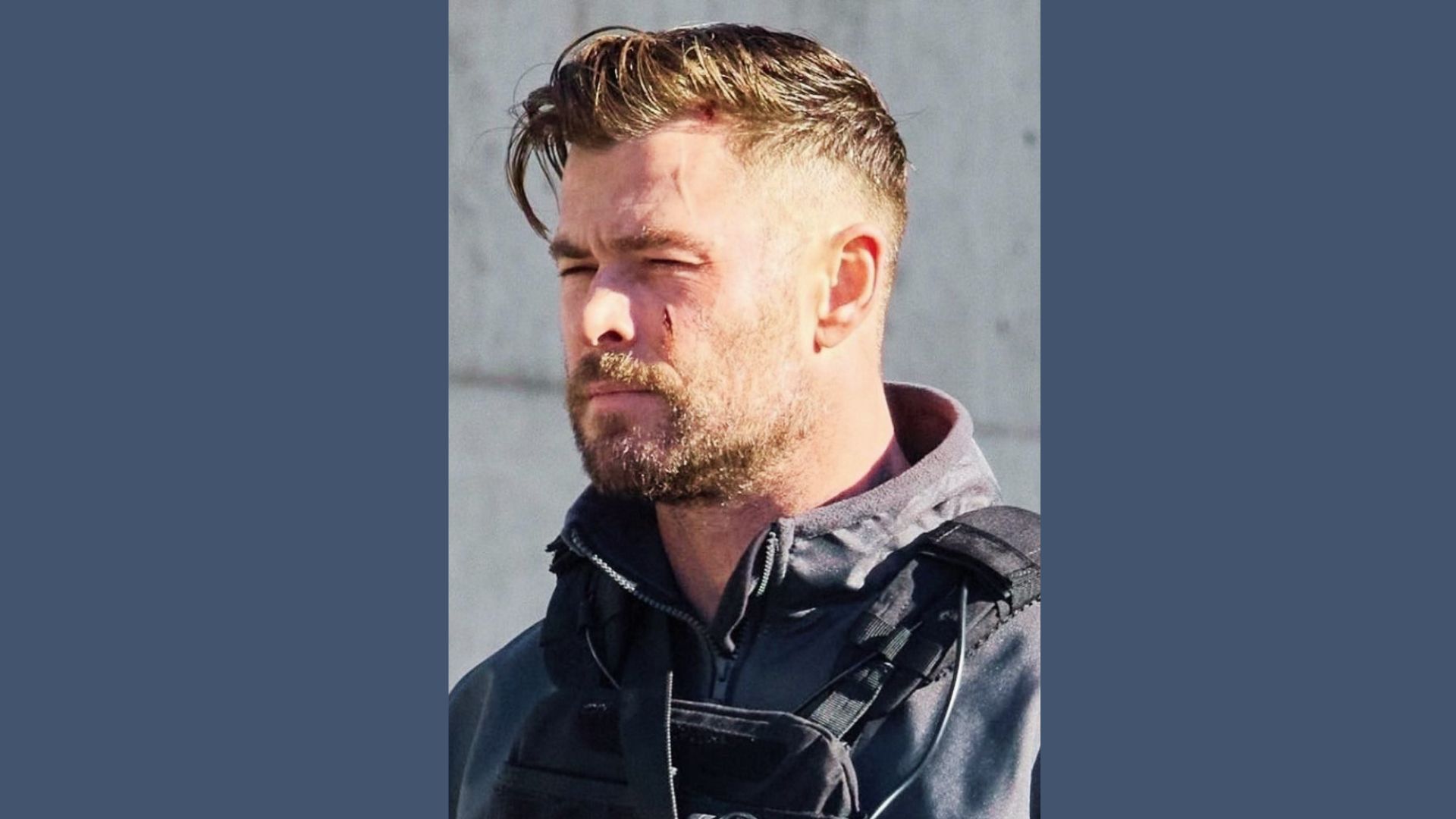 Chris Hemsworth's low fade haircut with a stylish combover, inspired by his look in the film Spiderhead.