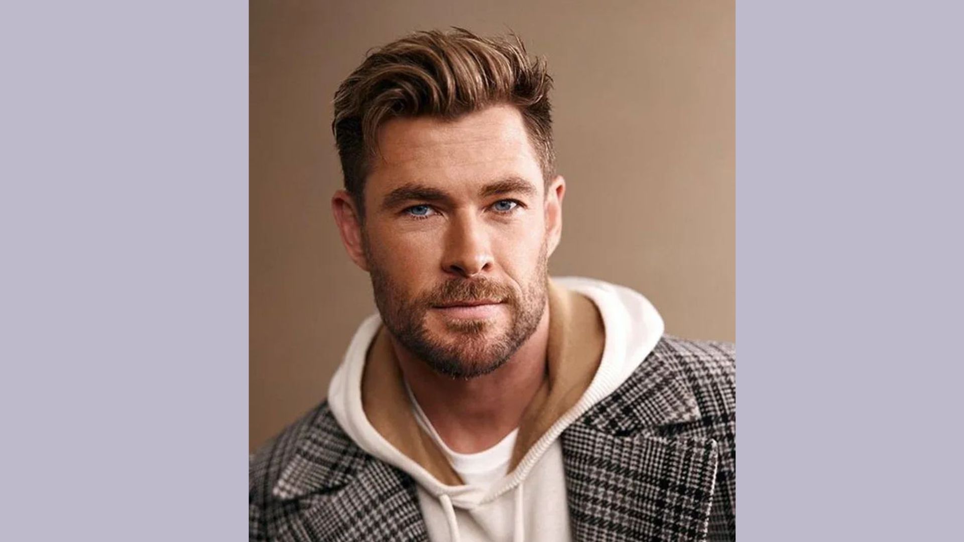 A bearded man in a white shirt, featuring a quiff hairstyle with tapered sides, inspired by Chris Hemsworth.