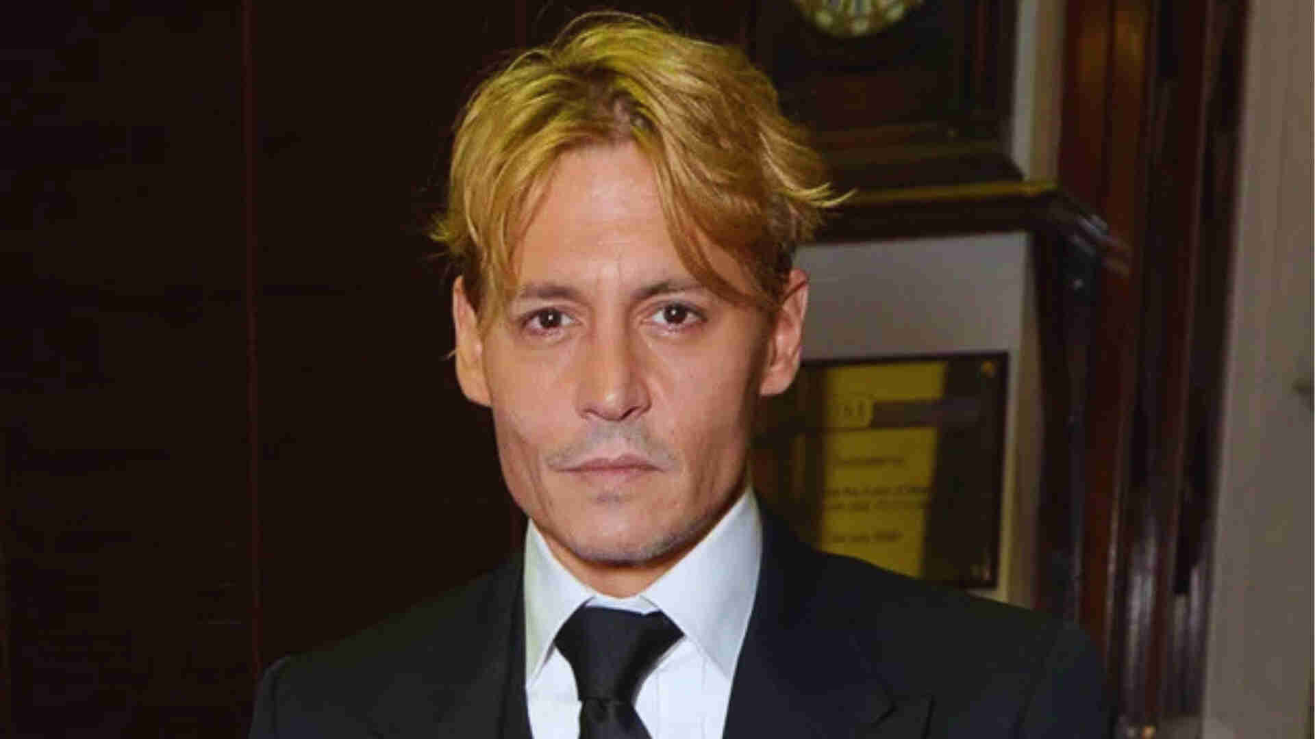 Dark blonde grunge waves on Johnny Depp with natural texture, relaxed messy finish, soft movement, and close-up face portrait