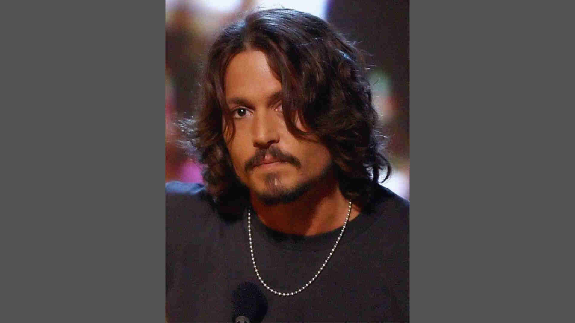 Feathered long layered hair on Johnny Depp with soft outward flicks, smooth texture, and detailed face close-up