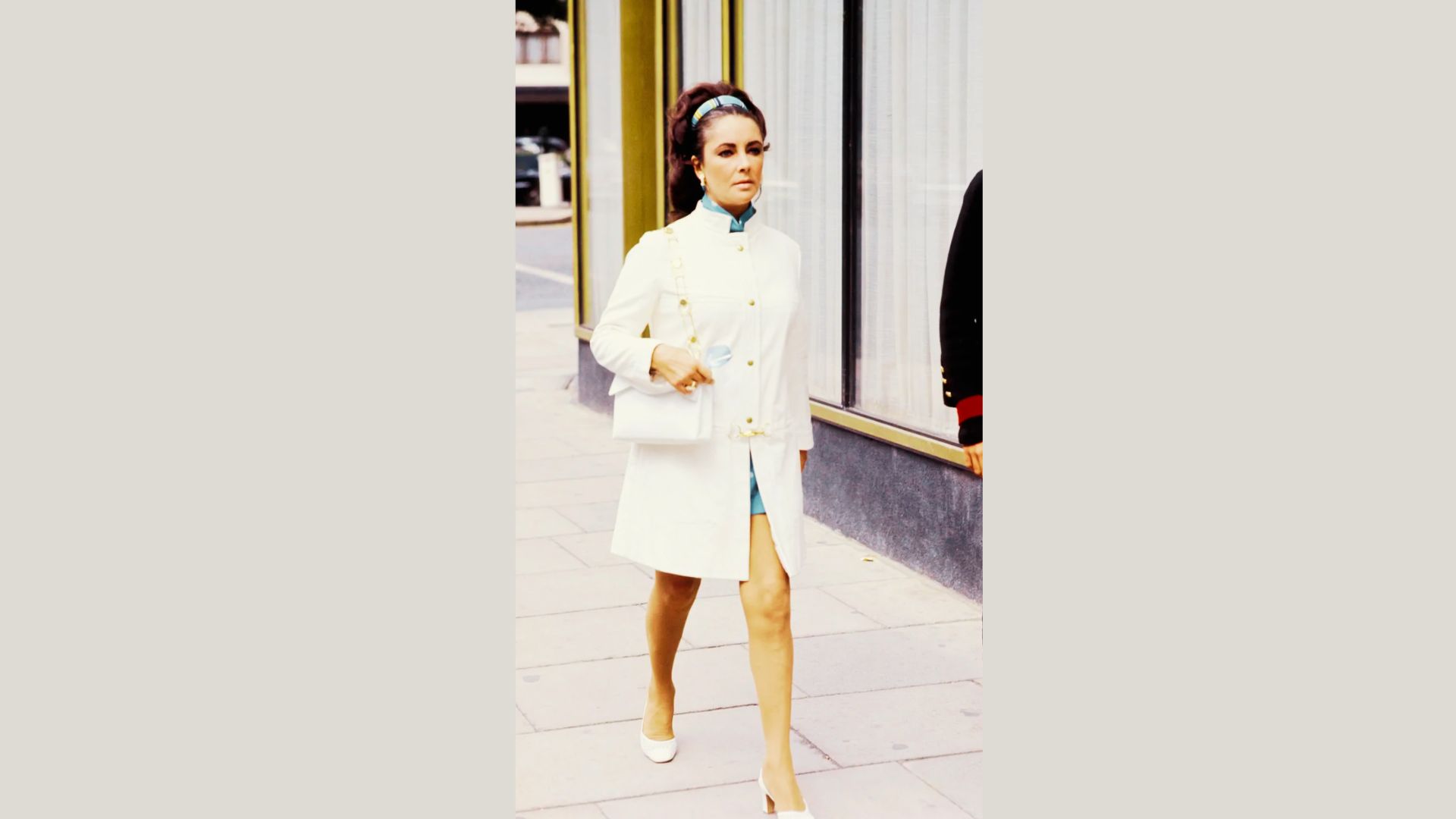 Elizabeth in white blouse and a white skirt.