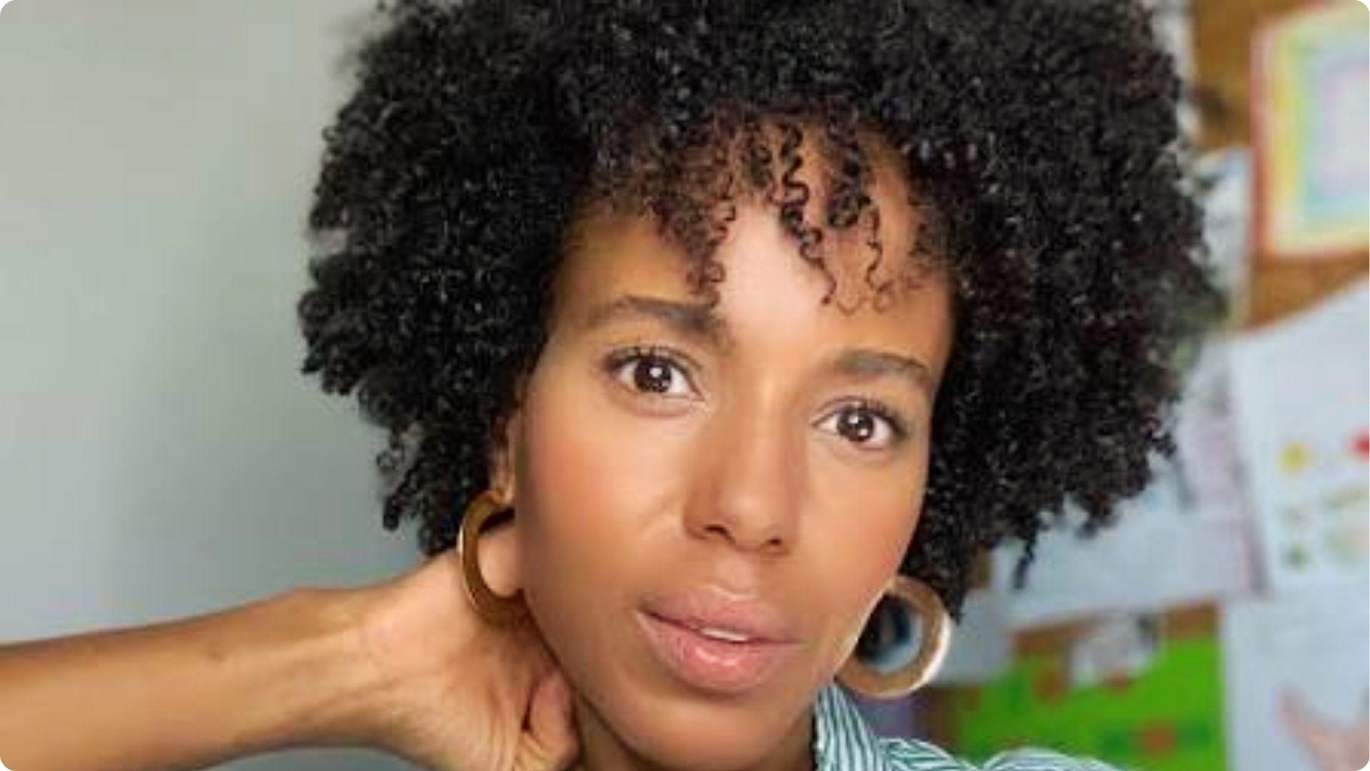 Kerry Washington with natural curly afro wearing large gold hoop earrings in her instagram post.