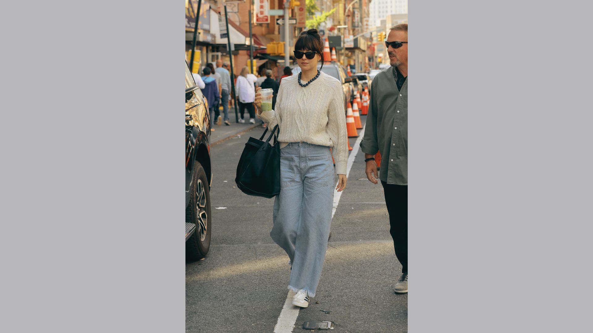 Woman wearing an oversized knit sweater with jeans.