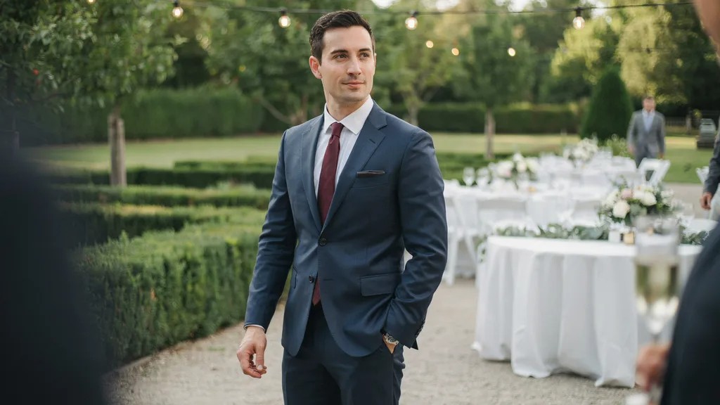 Man wearing a navy suit for a semi formal wedding