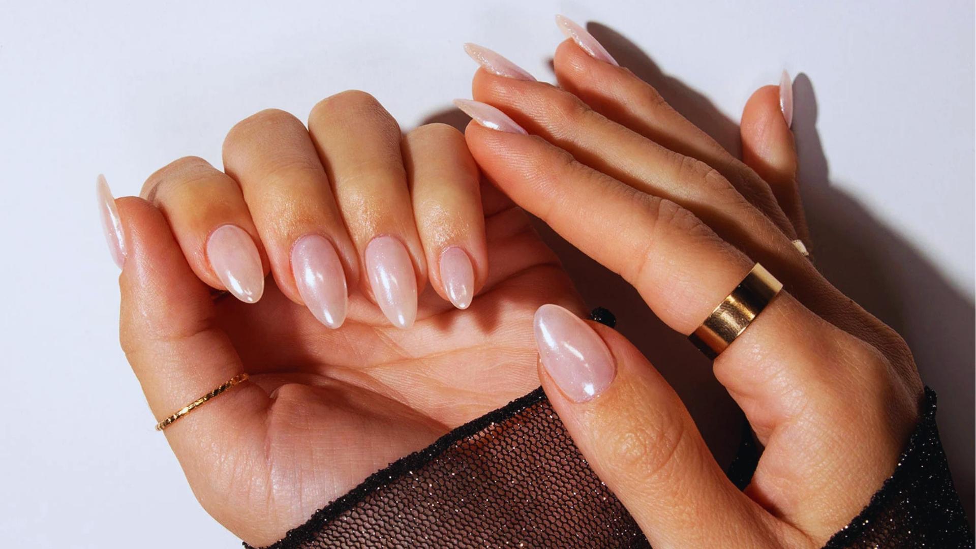 Long coffin-shaped nails with glossy baby pink jelly finish and subtle ombré fade, a soft Hailey Bieber staple.