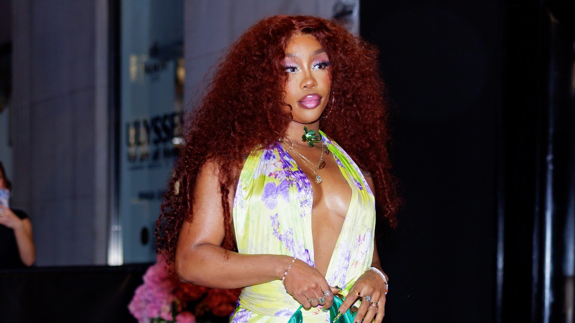 SZA showcases waist-length loose waves, promoting Nicki Minaj's new album 'Barbie Tingz' with a stylish appearance.