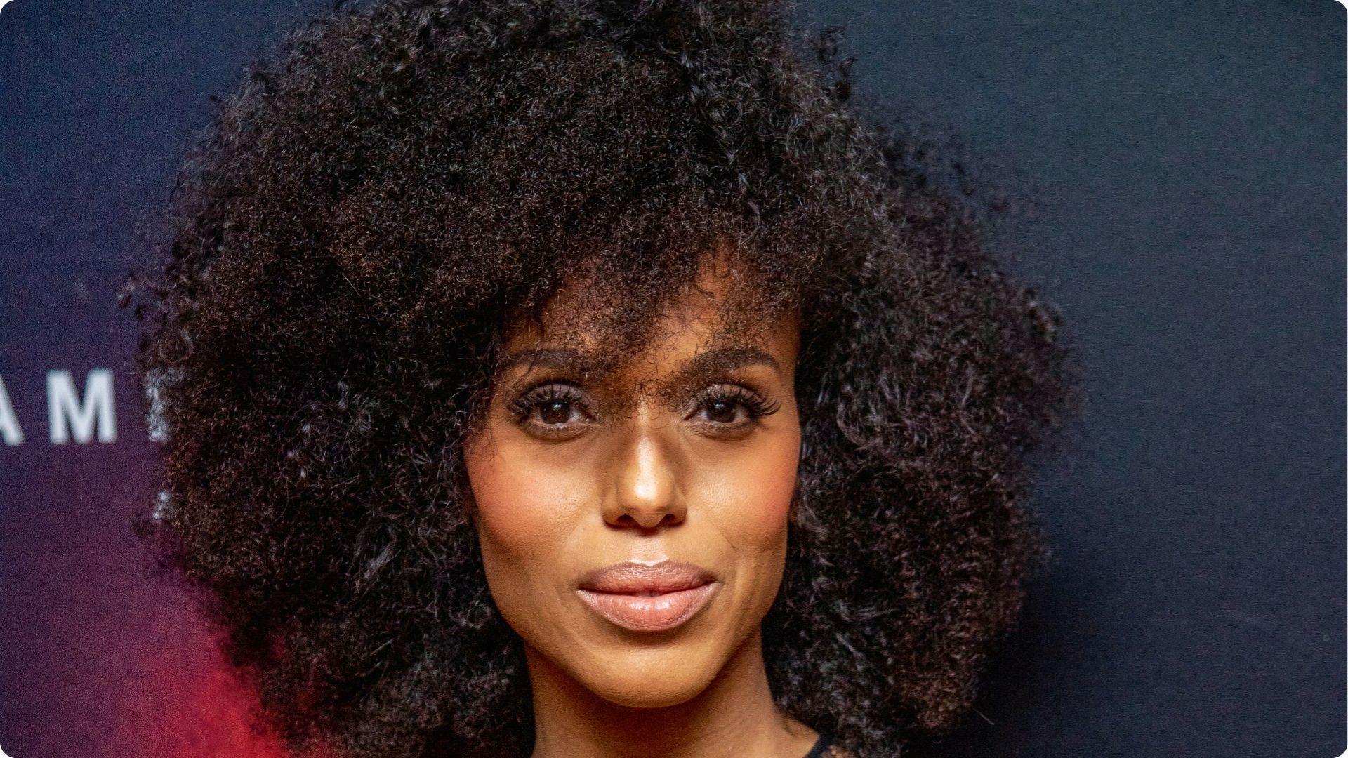 Kerry Washington with big voluminous natural curly afro hair and soft pink lip makeup close up
