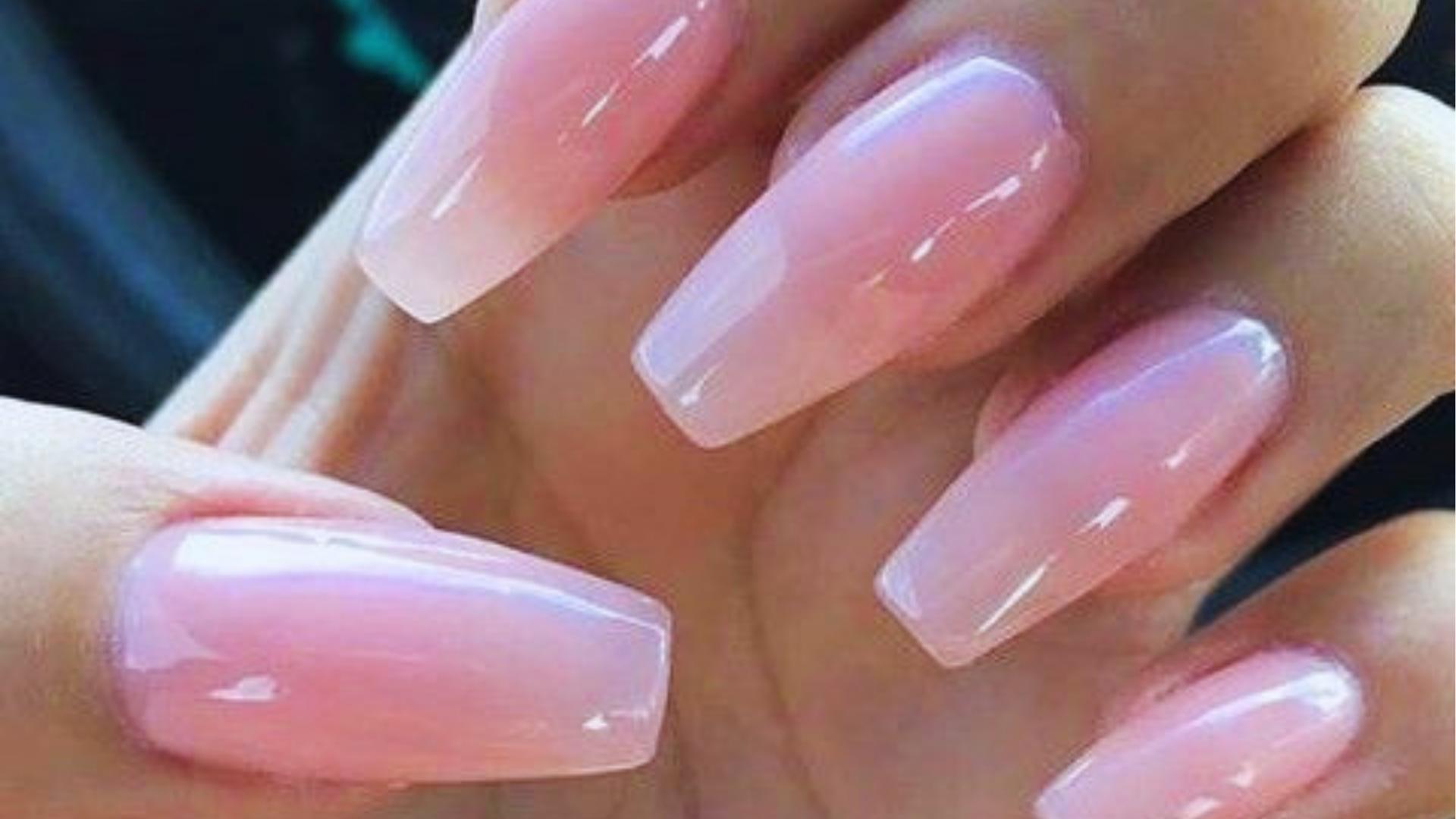 Long coffin nails with sheer pink jelly polish and subtle milky ombré fade, a soft Hailey Bieber-influenced clean girl staple.