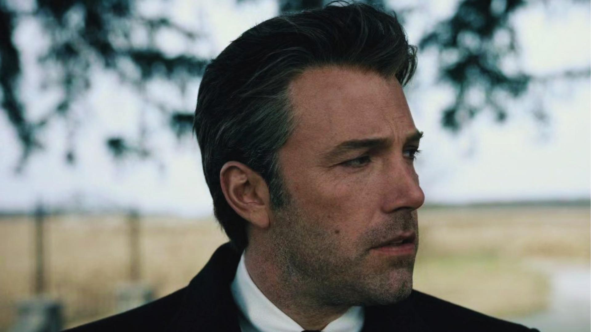 Ben Affleck as older Bruce Wayne with salt and pepper slicked back hair outdoors in Justice League.