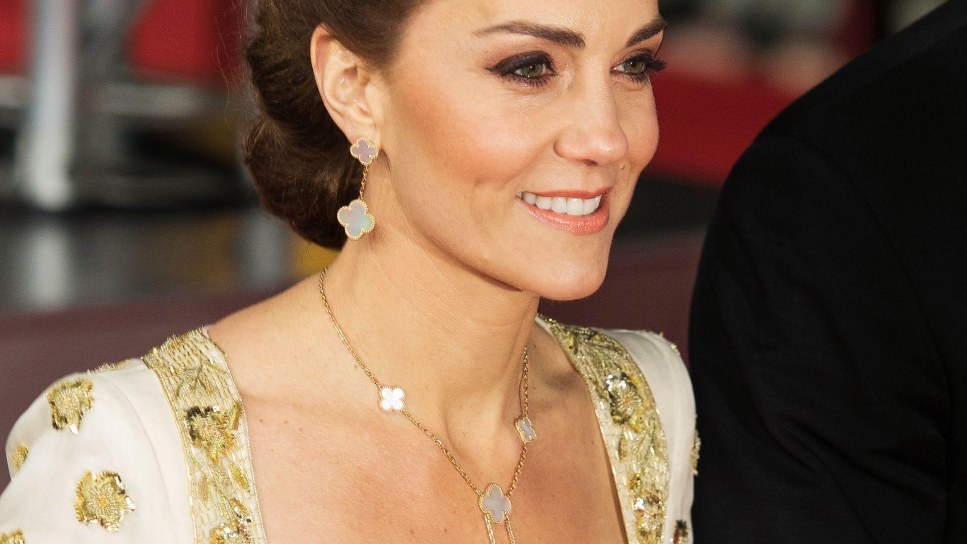 Close-up of Kate Middleton at BAFTA wearing Van Cleef Alhambra mother-of-pearl drop earrings with matching necklace and gown