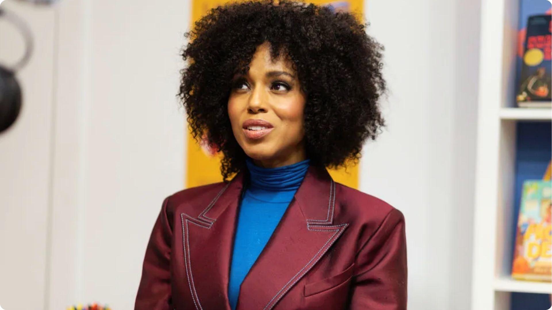 Kerry Washington in burgundy blazer and blue turtleneck with voluminous natural curly hair