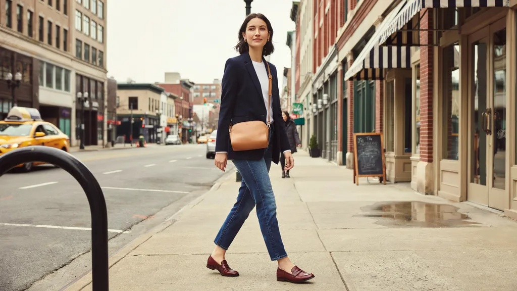 Navy blazer styled casually with denim and loafers.