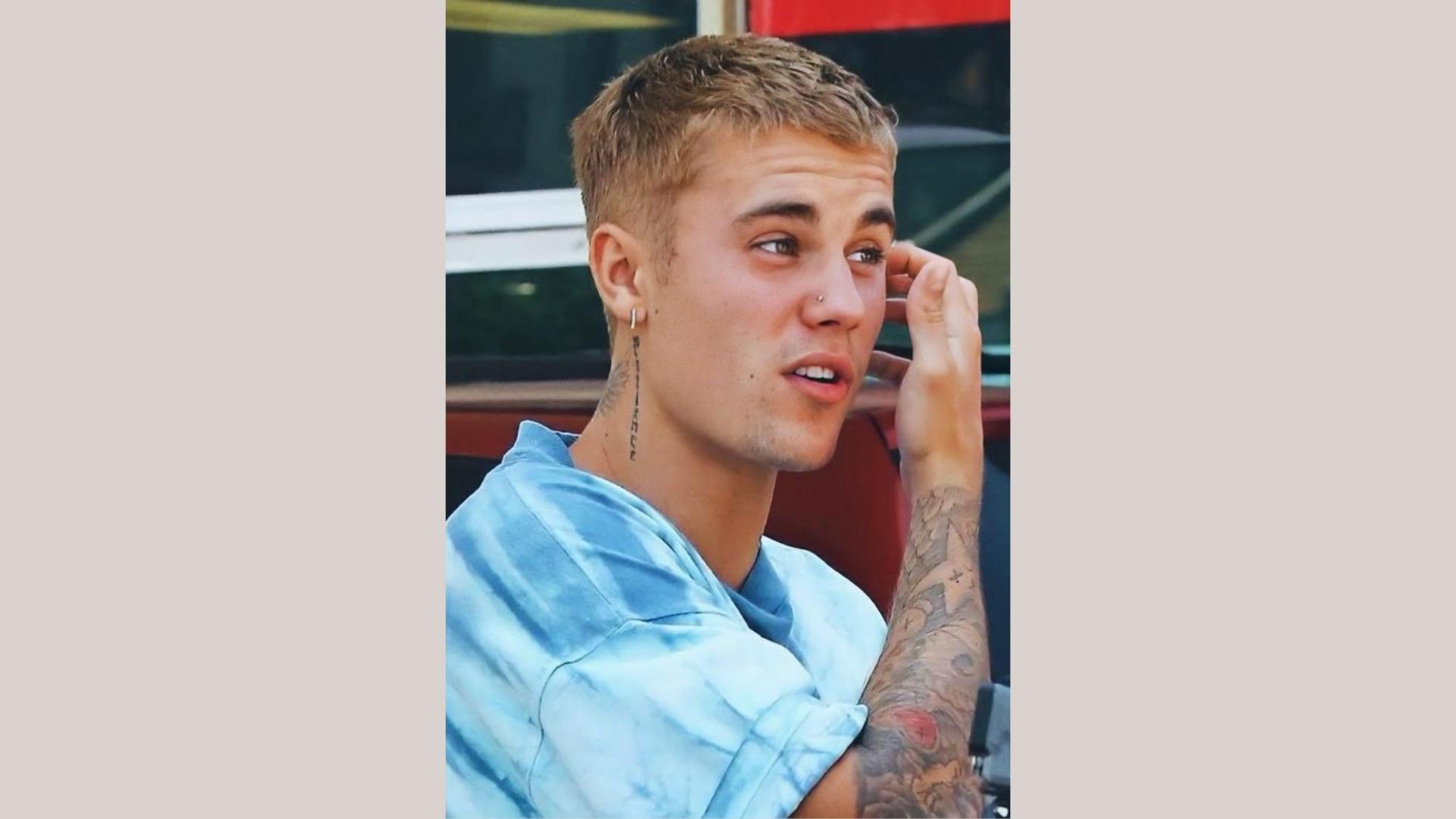 Justin Bieber short textured crop haircut in tie dye shirt, casual short hairstyle inspiration.