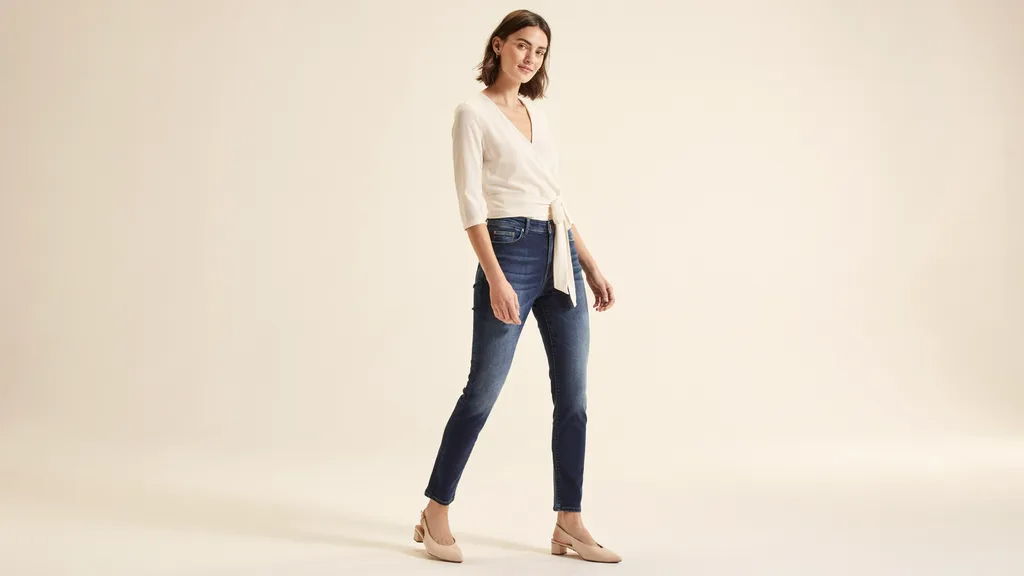 Woman wearing a flattering wrap top designed for a short torso and long legs.