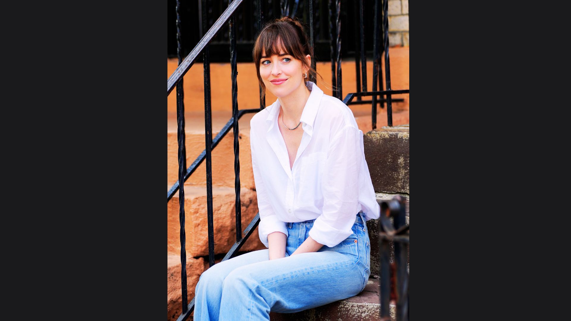 White button-down shirt paired with baggy jeans.