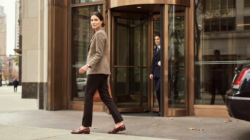 Tweed blazer paired with black trousers for a polished outfit.
