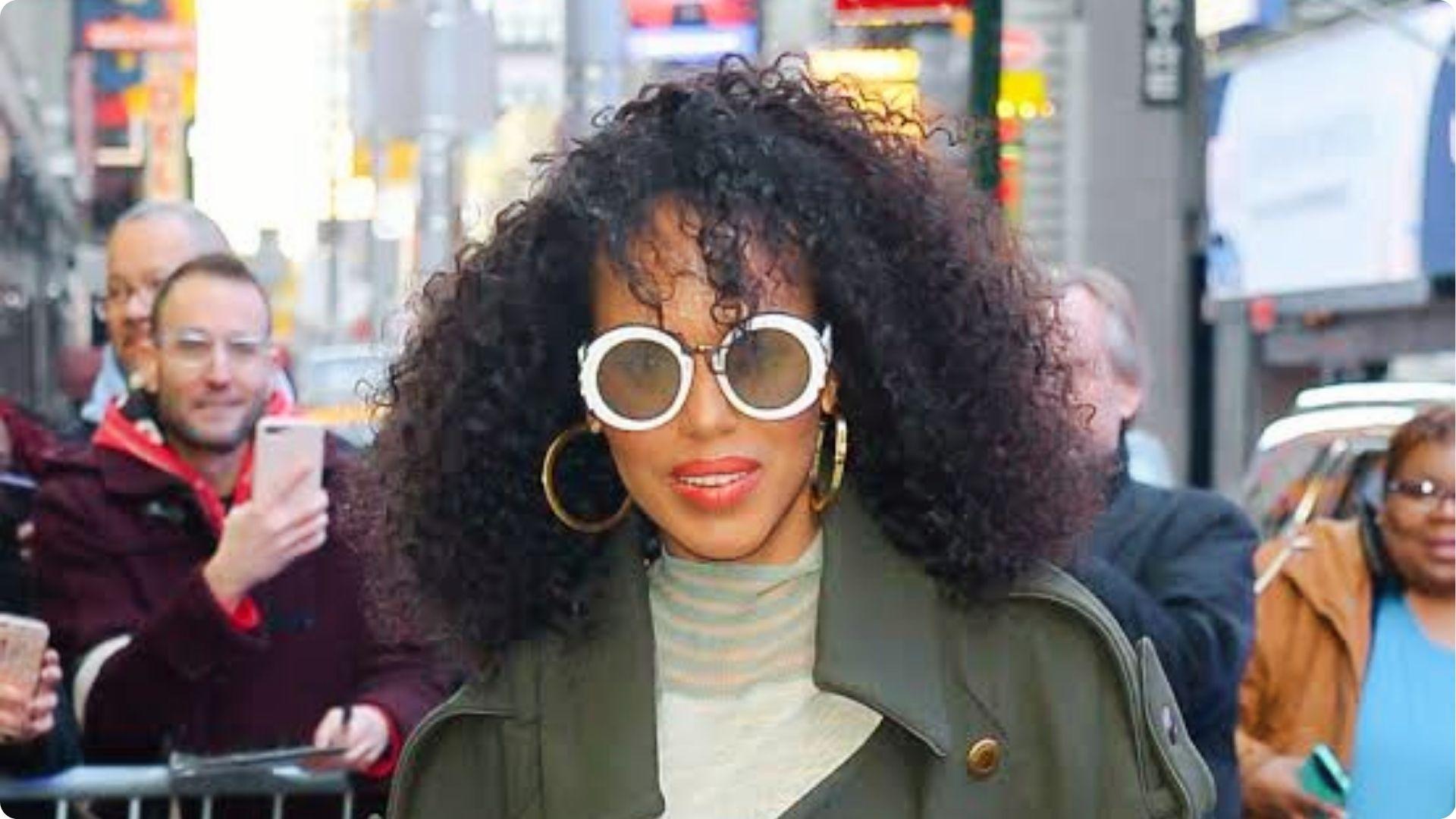 Kerry Washington flaunts natural curly hair with white round sunglasses and gold hoops on street