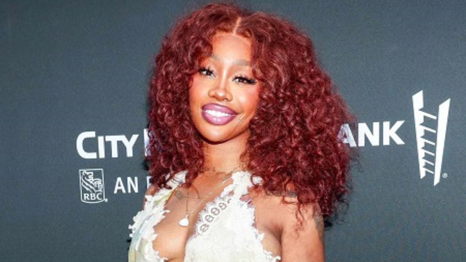 SZA flaunts her striking red curls, embodying her artistic persona in a recent event.