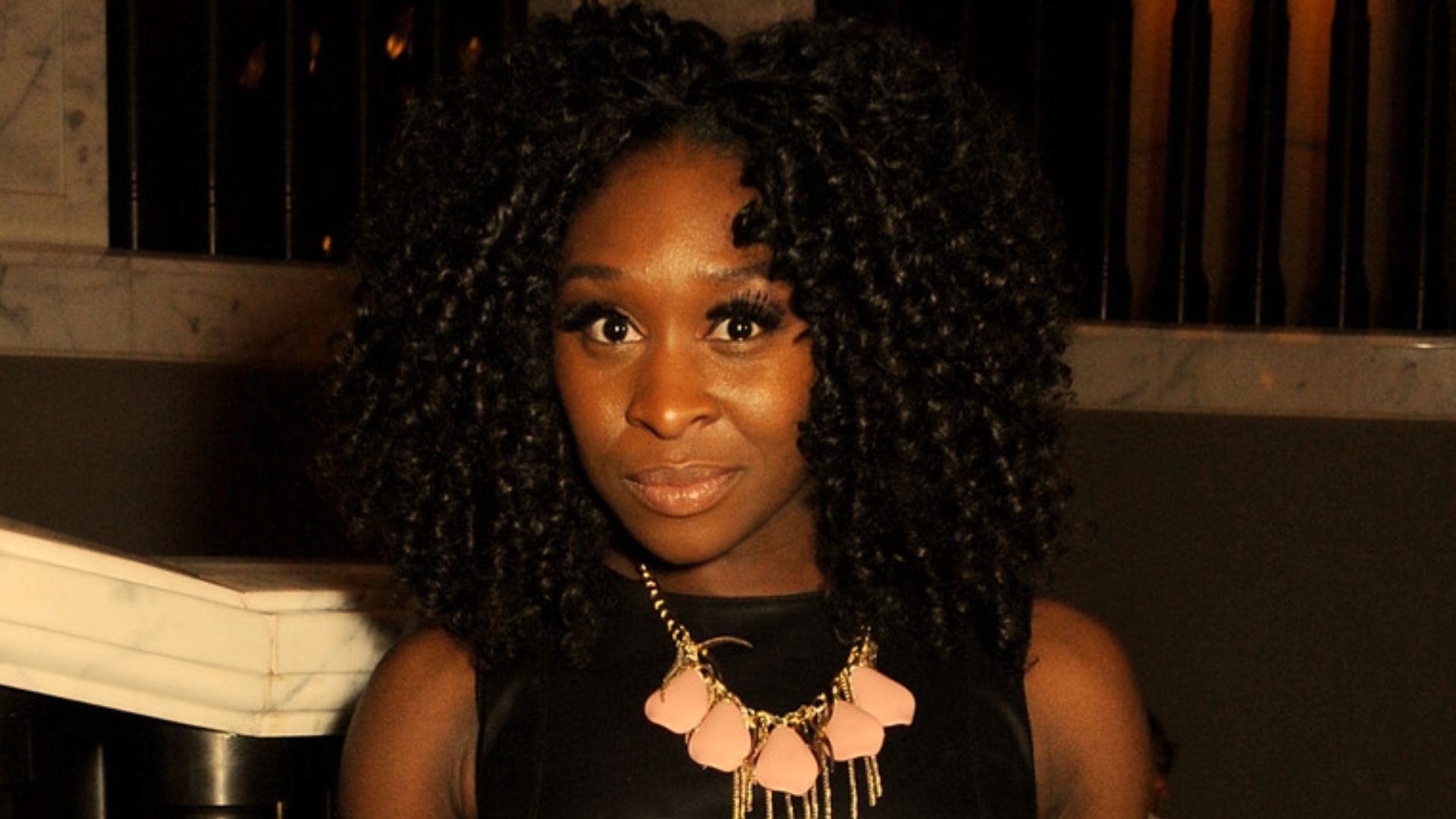 Cynthia Erivo with natural curly hair during early career years.