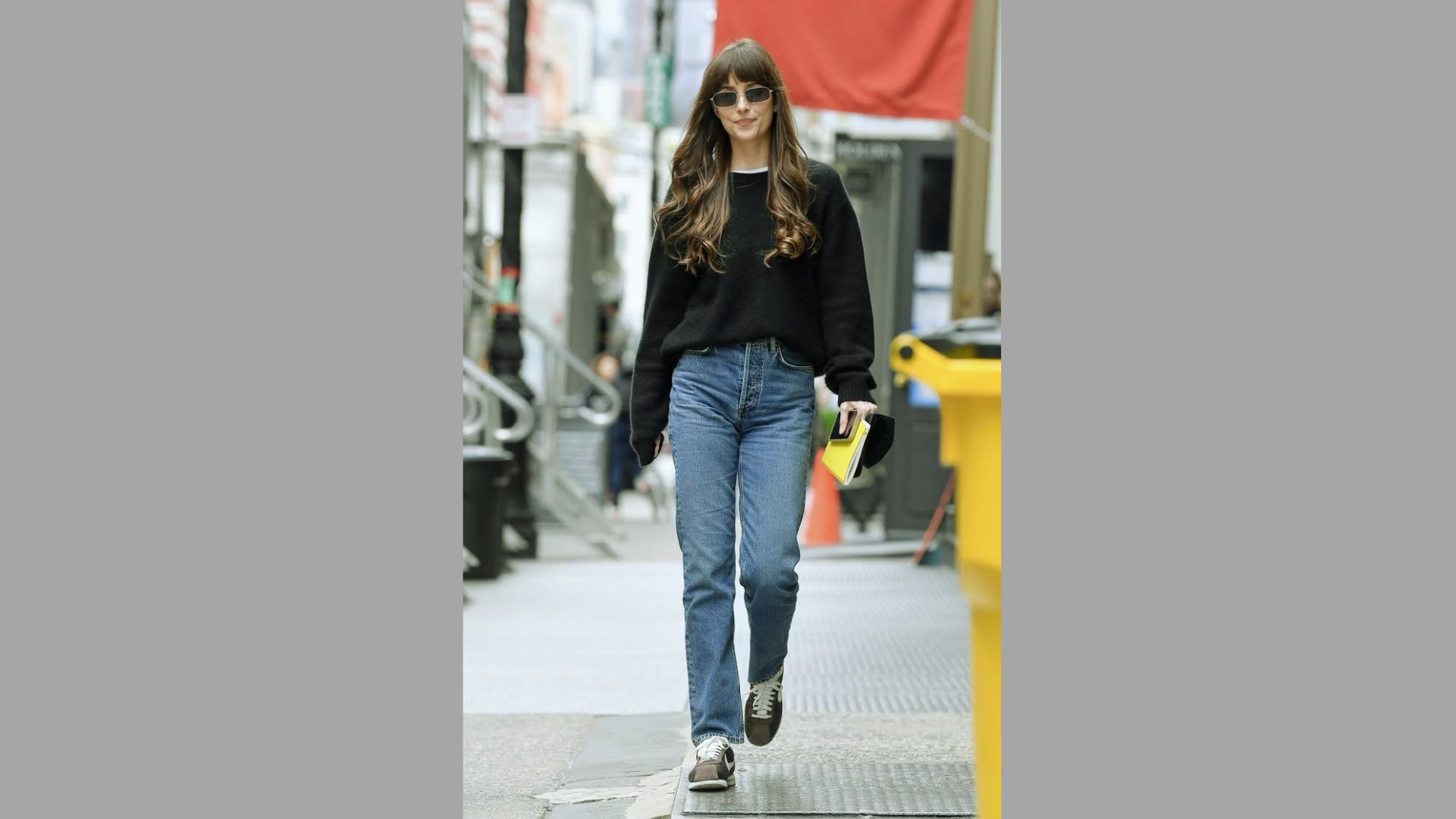 Oversized sweater outfit styled with jeans and trainers.