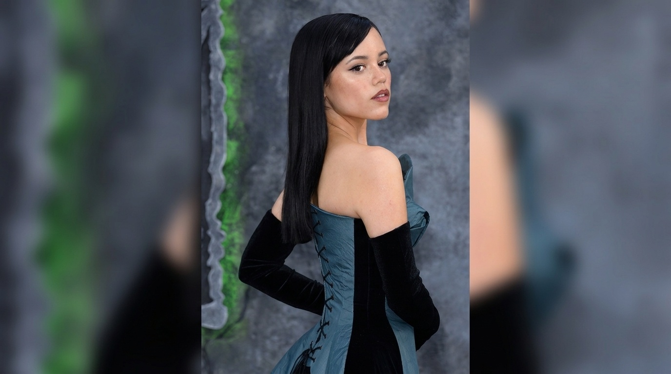 Jenna Ortega with sleek straight brunette hair and a center-part hairstyle.