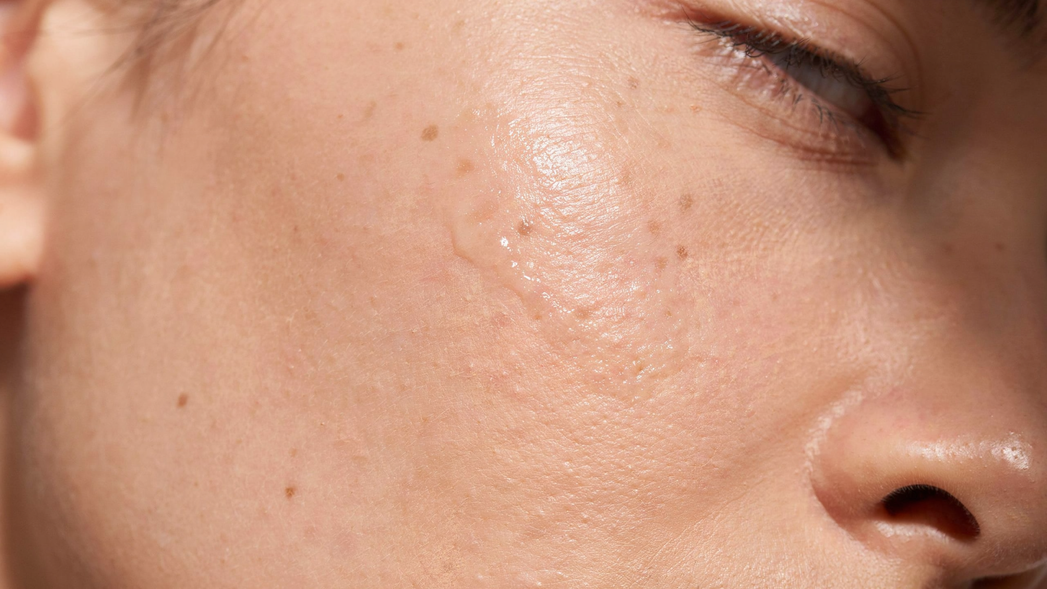 natural skin with sheer tinted moisturizer blended evenly showing dewy finish smooth texture and minimal coverage enhancing healthy natural complexion appearance.