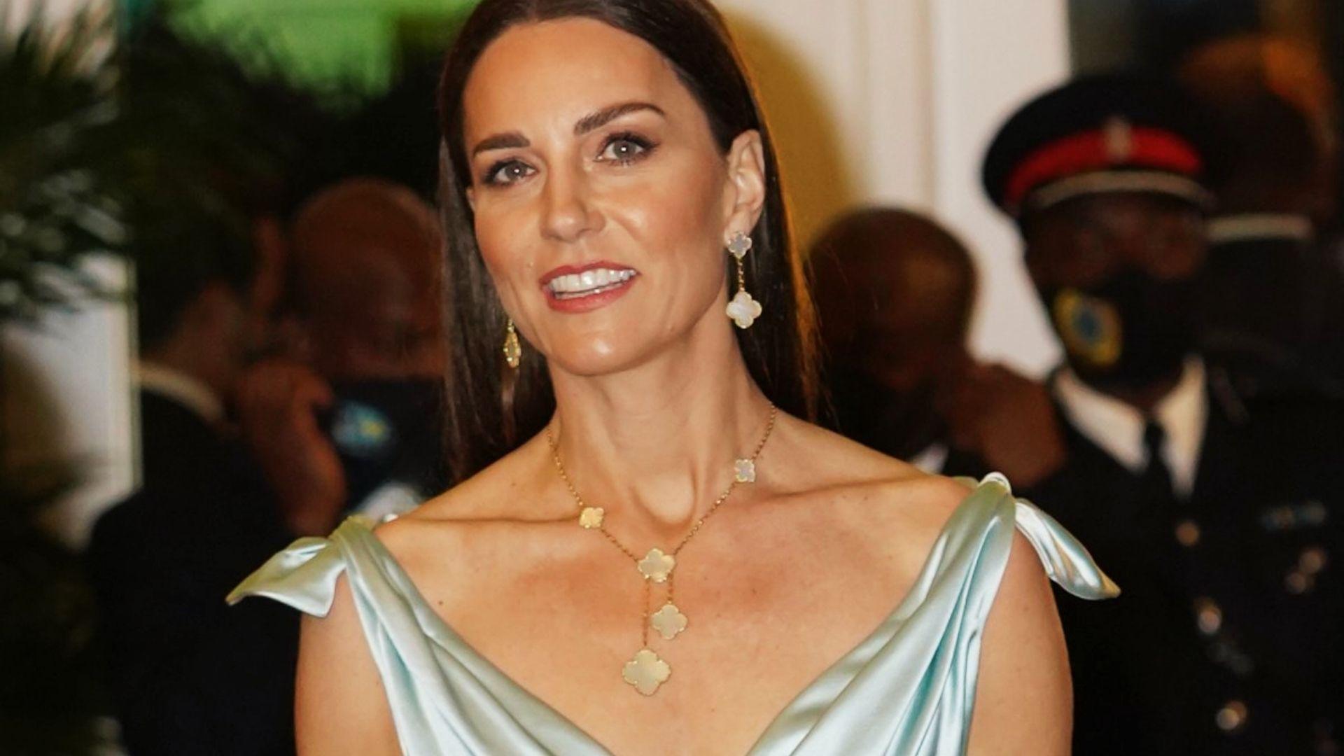 Kate Middleton in light blue satin gown wearing Van Cleef Alhambra earrings and necklace during royal tour event