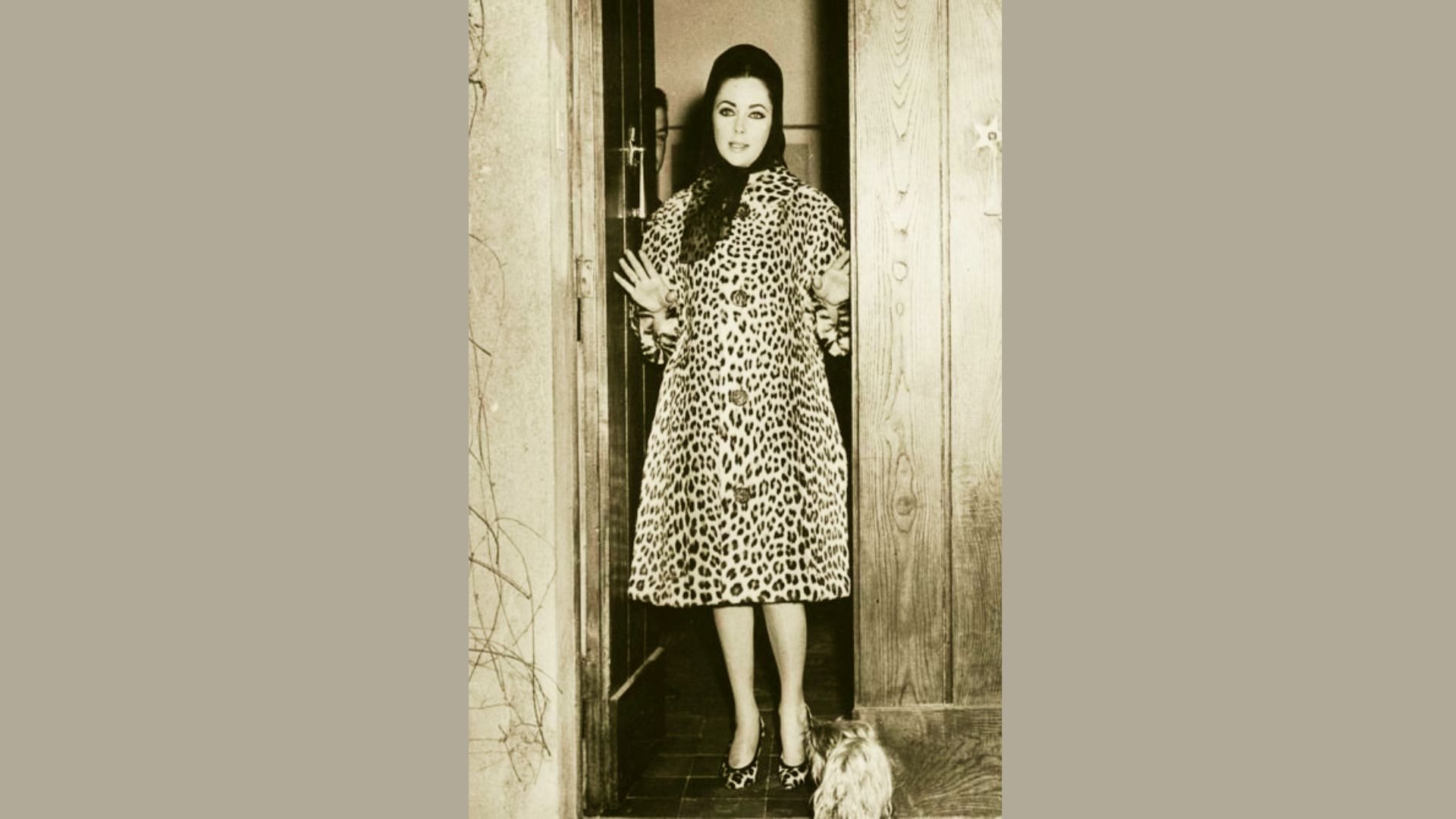 Elizabeth Taylor in leopard print coat at a doorway